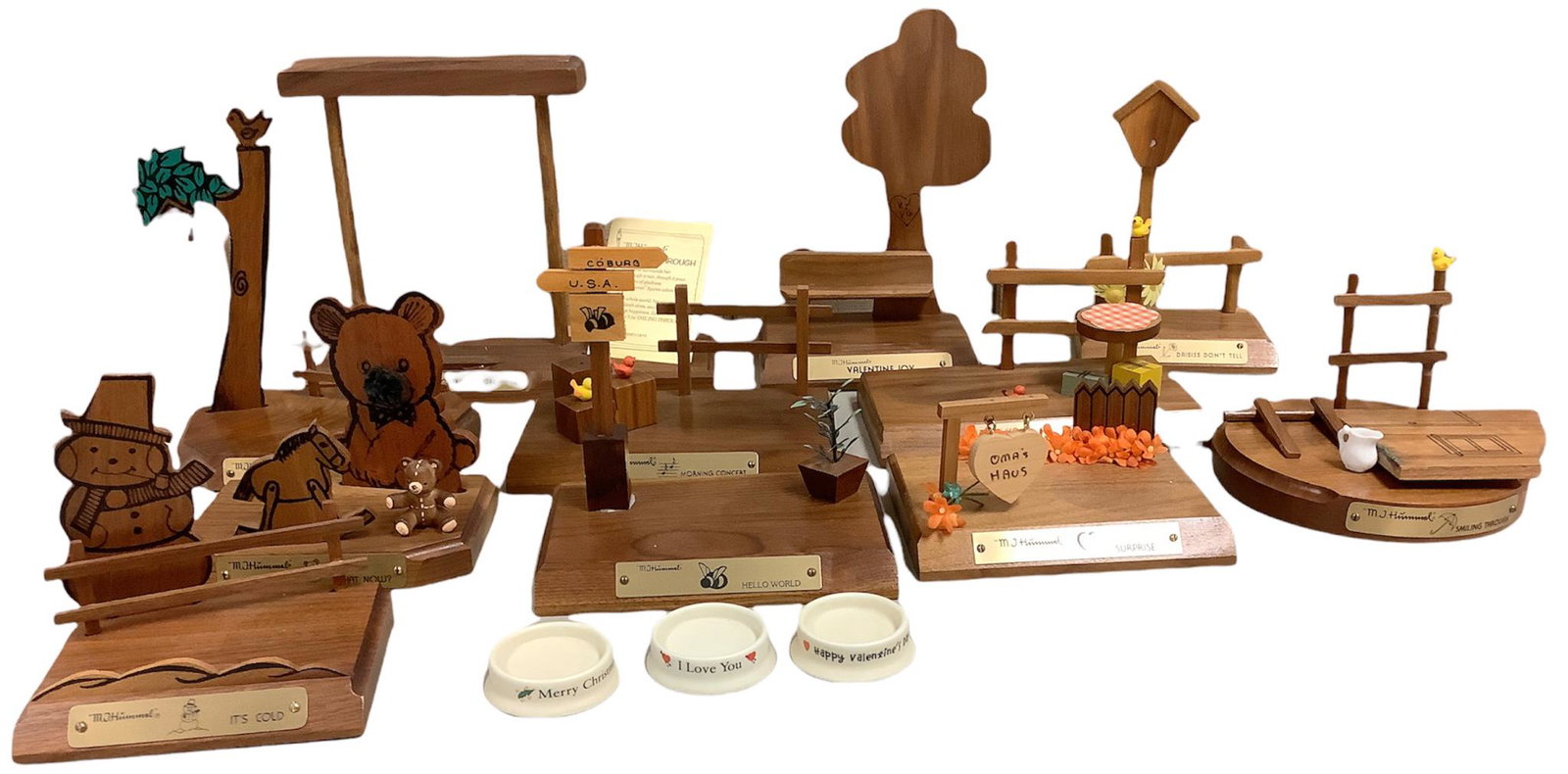 Lot of 11 wooden Hummel figurine display stands and 3 porcelain Hummel display stands. (1 of 1)