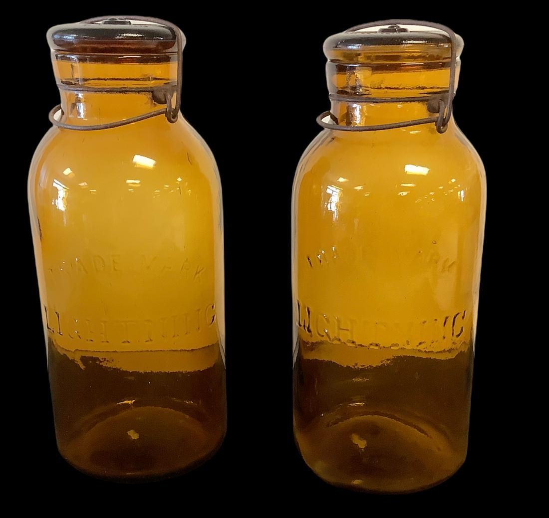 Pair of 10" high jars Trade Marked Lighting, Made in Newark, Ohio, color Amber. (1 of 1)