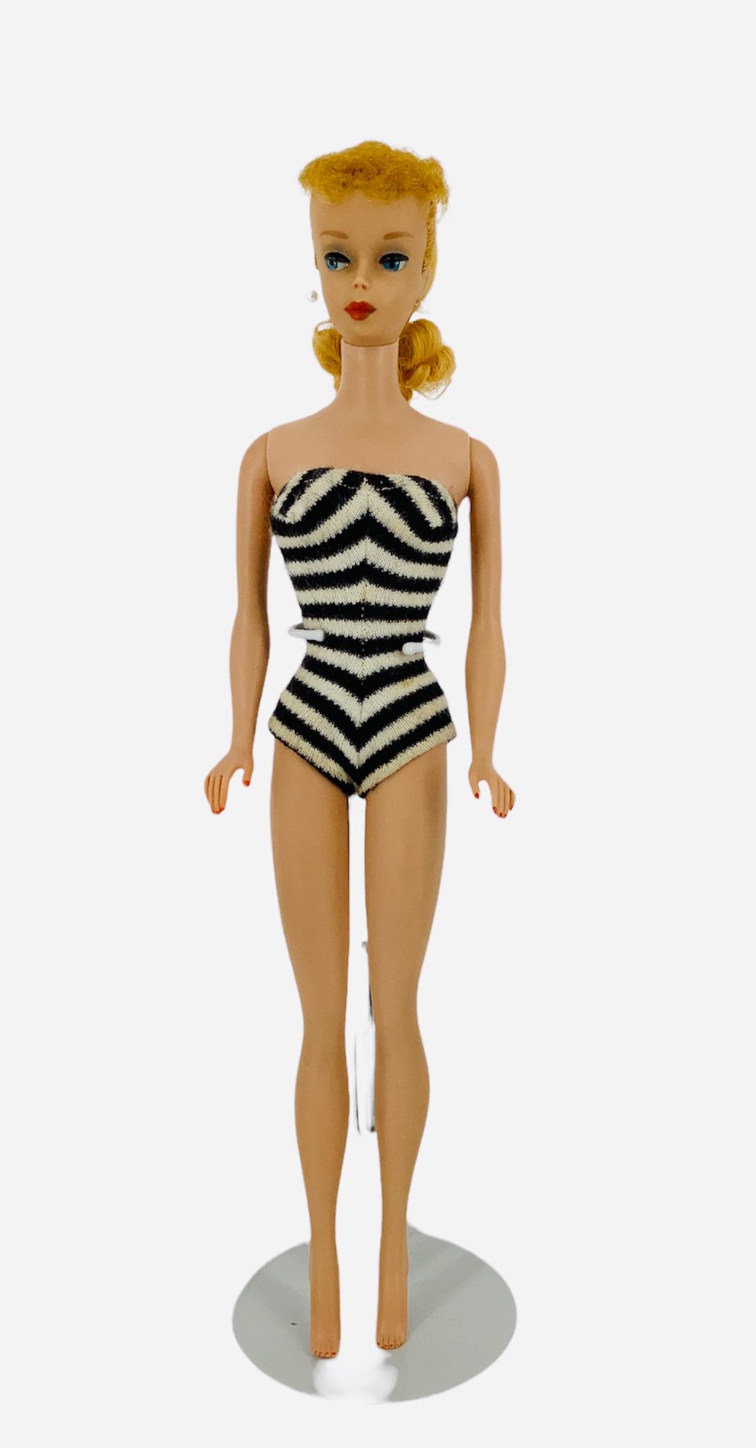 No. 5 Blonde Ponytail Barbie (hollow body). Hair in original set, nail and facial paint good, doll (1 of 2)