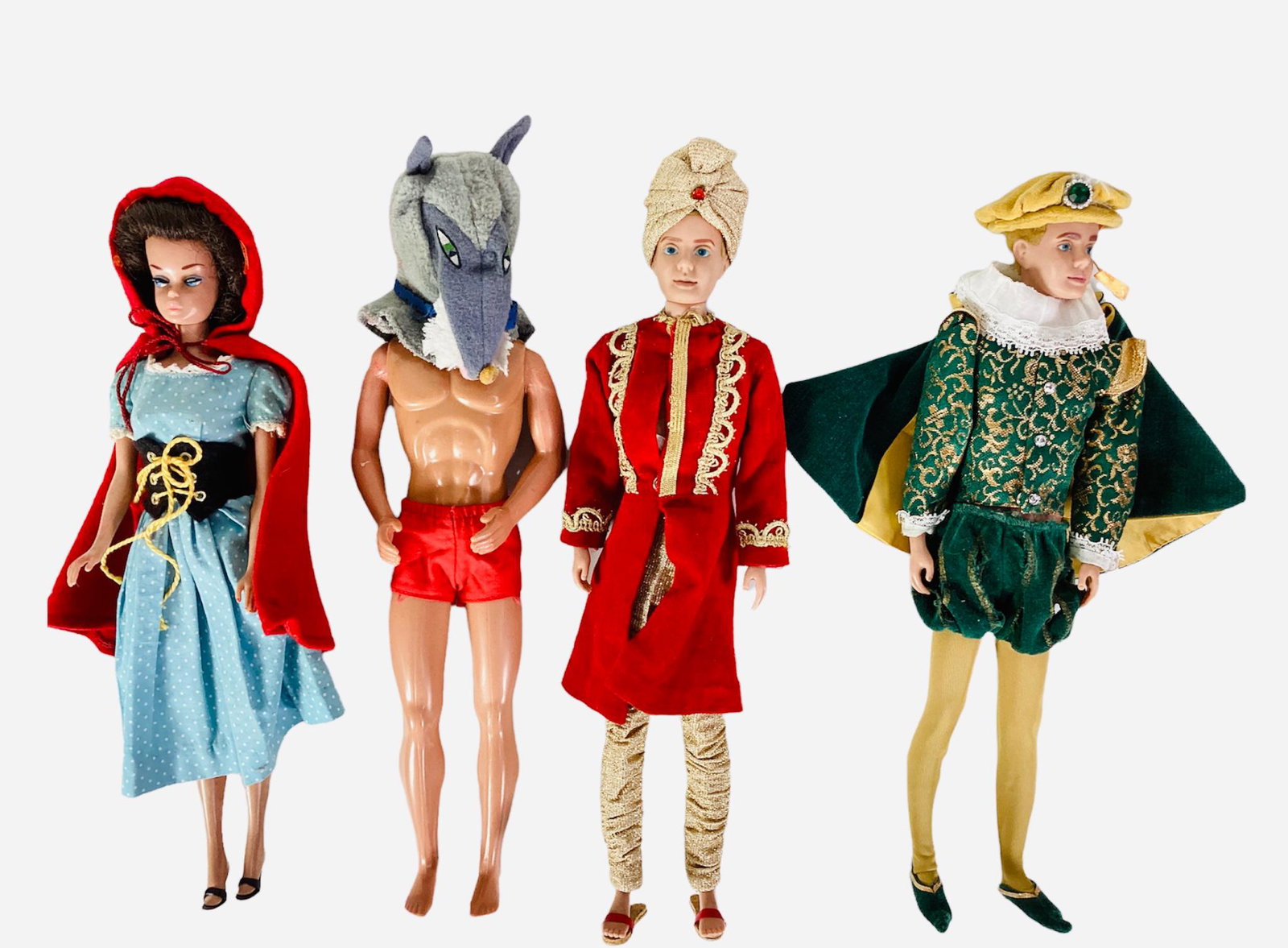 (4) Barbie & Ken in Little Theatre Costumes. Starting with (1) Ken as the Prince who comes with: (4) Barbie & Ken in Little Theatre Costumes. Starting with (1) Ken as the Prince who comes with blond flocked hair which is missing at the pillow and w and wearing the costume, tights, shoes, hat,