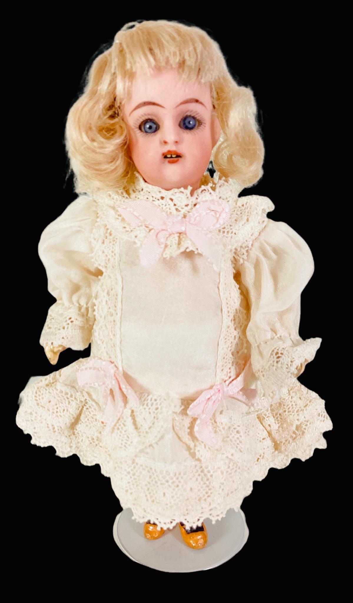 Simon & Halbig K&R bisque socket head girl. 6" doll with mohair wig, glass sleep eyes, open mouth: Simon & Halbig K&R bisque socket head girl. 6" doll with mohair wig, glass sleep eyes, open mouth with teeth, on five-piece walker body with molded and painted two-strap shoes and stockings. Bisque ha