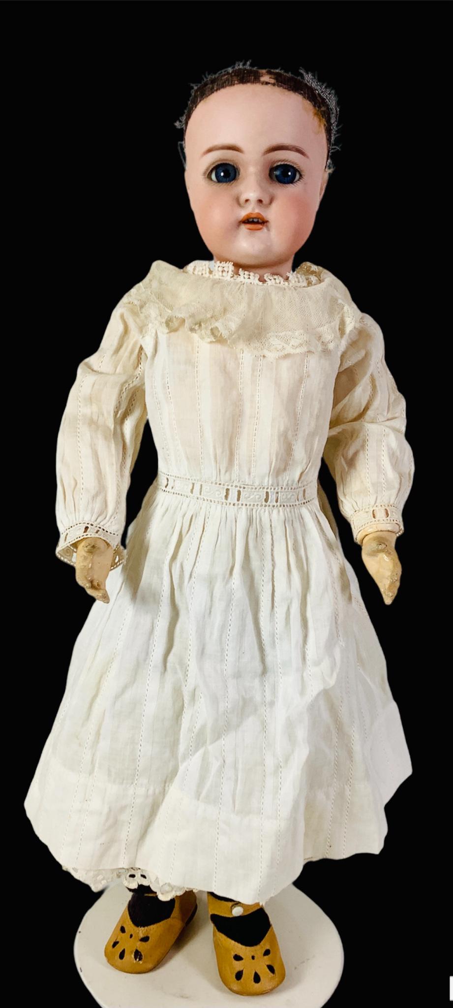 Heinrich Handwerck 79 bisque socket head girl. 18" doll with glass sleep eyes, pierced ears, open: Heinrich Handwerck 79 bisque socket head girl. 18" doll with glass sleep eyes, pierced ears, open mouth with teeth, on jointed composition body stamped "Germany" on lower rear torso. Small bisque chip