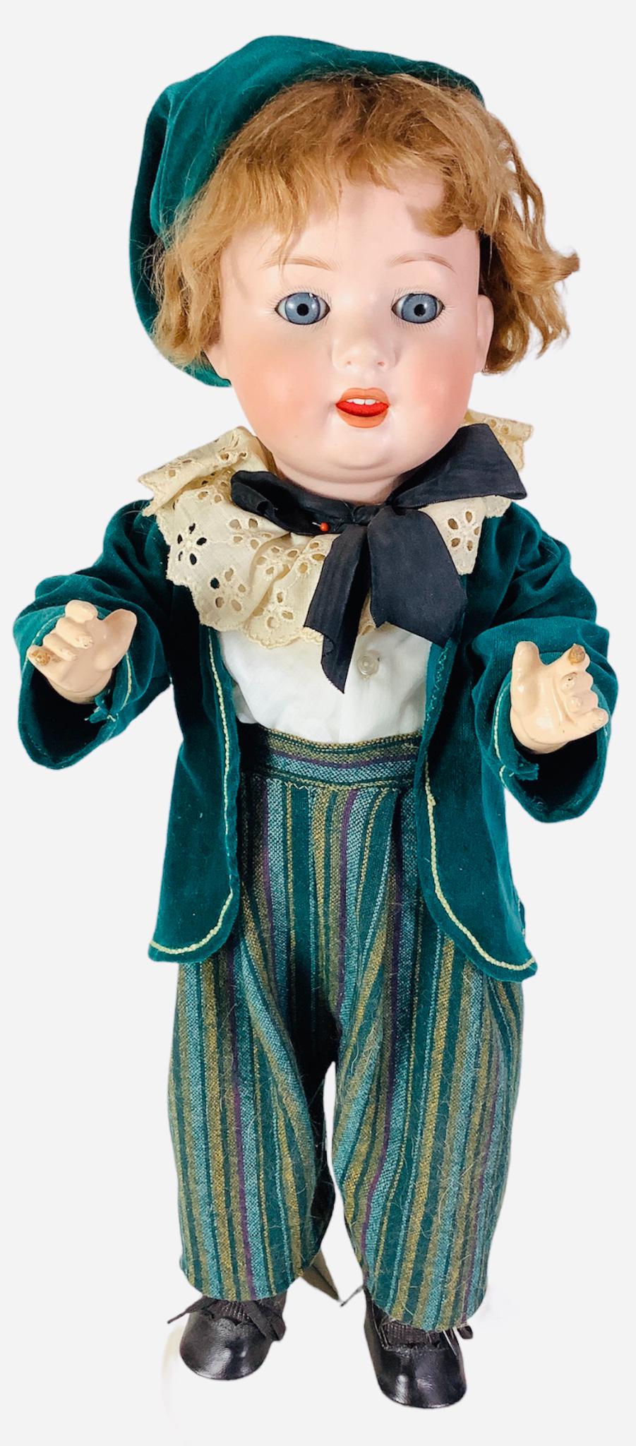 PHeubach Koppelsdorf 300 bisque socket head boy. 23" doll with mohair wig, glass eyes, open mouth: PHeubach Koppelsdorf 300 bisque socket head boy. 23" doll with mohair wig, glass eyes, open mouth with teeth, on five-piece composition body. Pate glued on and not removed for inspection.