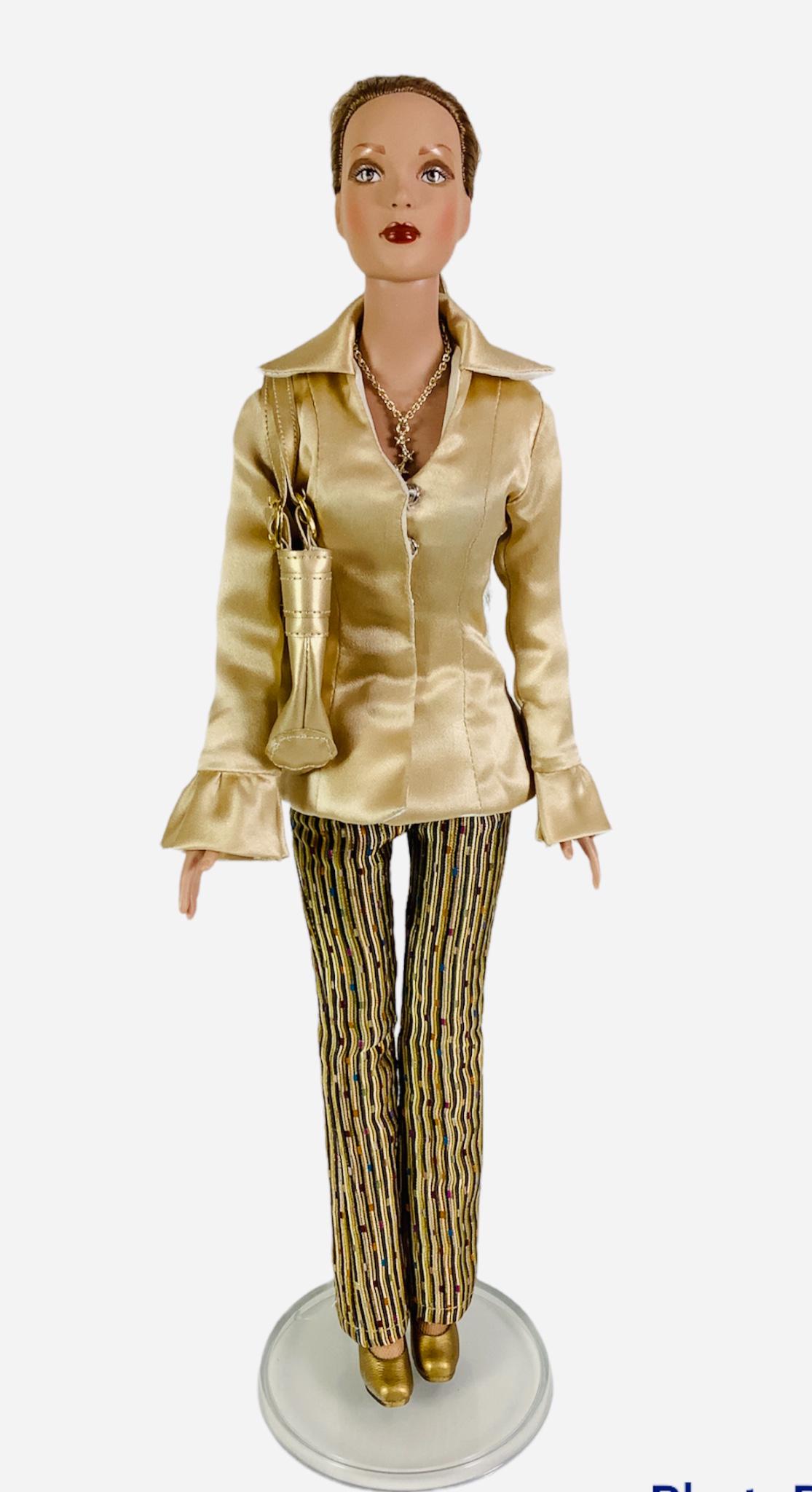 16" Tonner doll, redressed in gold blouse and gold and brown stripe pants, gold purse and shoes. No: 16" Tonner doll, redressed in gold blouse and gold and brown stripe pants, gold purse and shoes. No box.