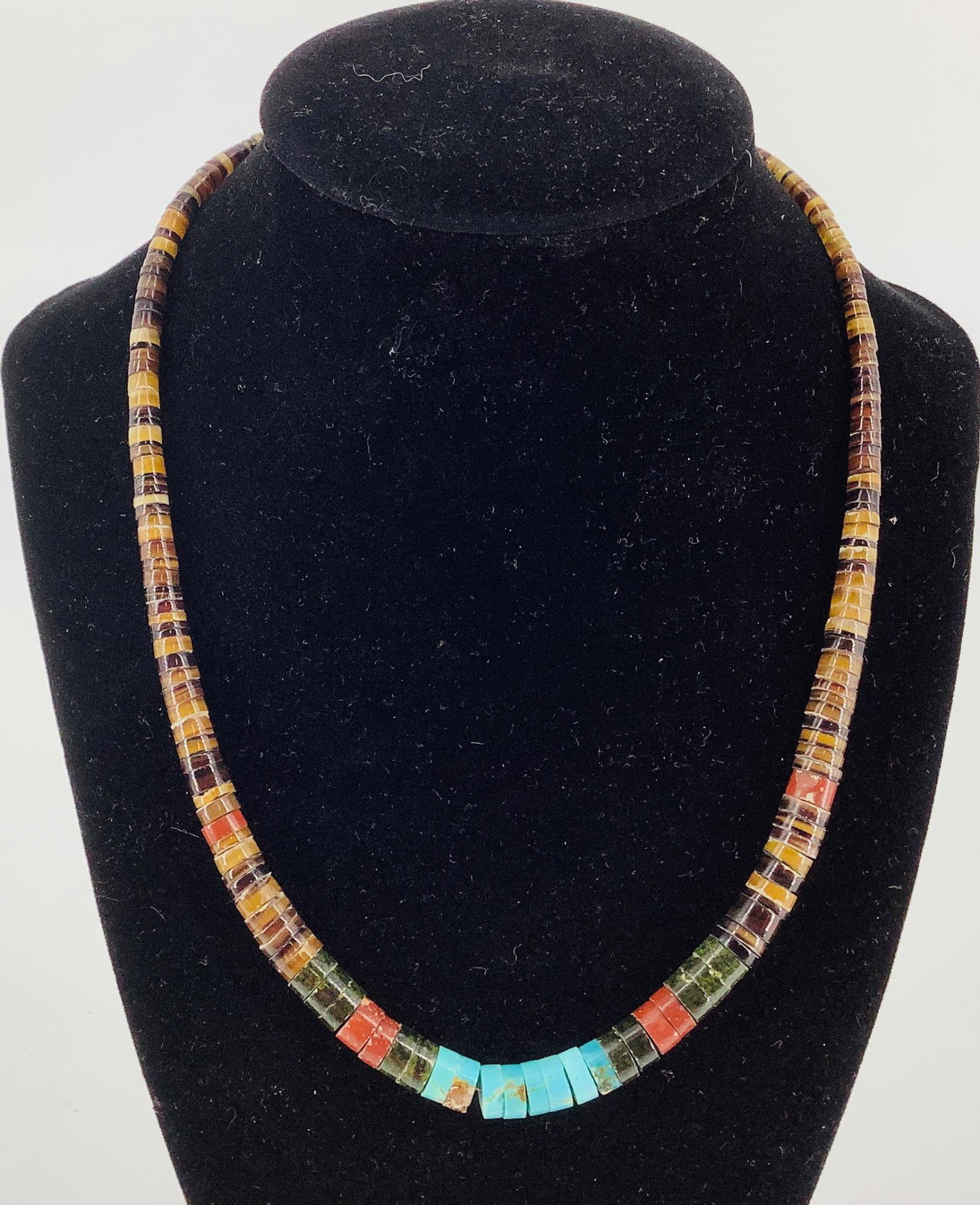Southwestern Style Necklace: Southwestern Style Necklace Graduated design featuring hand spun shell, jasper & turquoise beads finishing with a hook clasp closure ( approx. 18.25” in length)