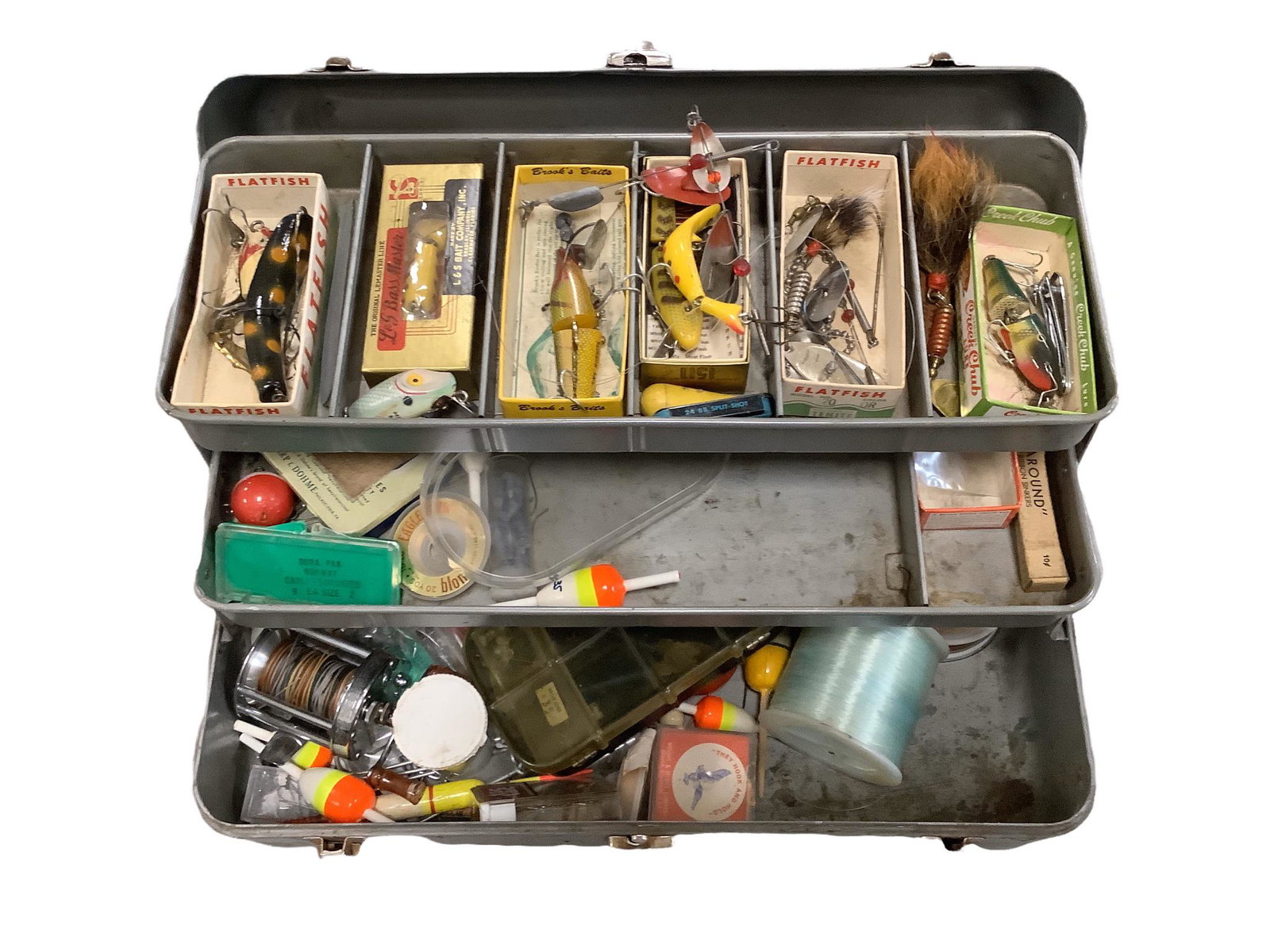 Loaded tackle box with lures and 1 bait casting reel.: Loaded tackle box with lures and 1 bait casting reel.
