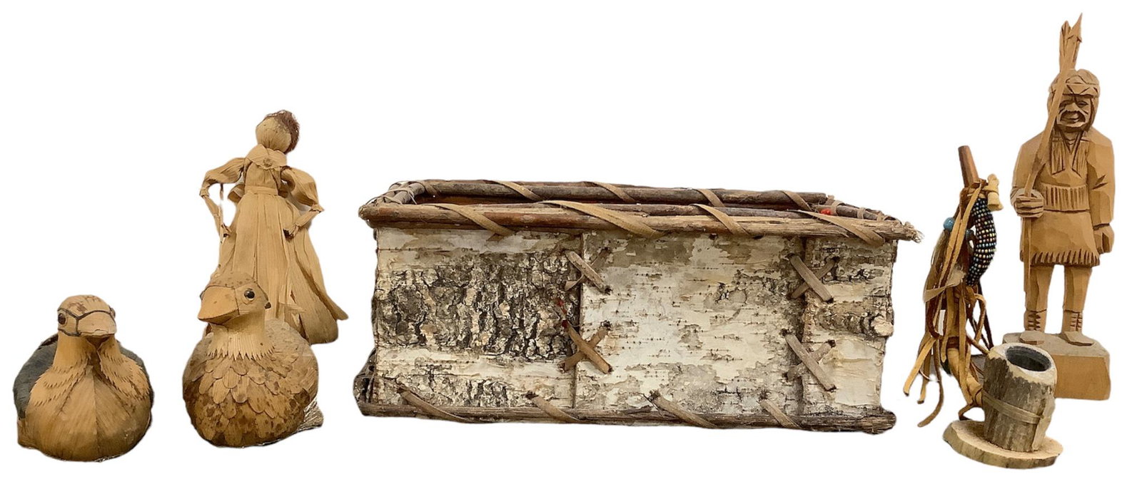 Lot including a birch bark basket, 11.5"L x 8"W x 5"H, a carved wooden Native American statue with: Lot including a birch bark basket, 11.5"L x 8"W x 5"H, a carved wooden Native American statue with broken spear, 9"h, 2 small hollow wooden ducks, a ornamental pipe, 6.25"h, and a corn husk doll.