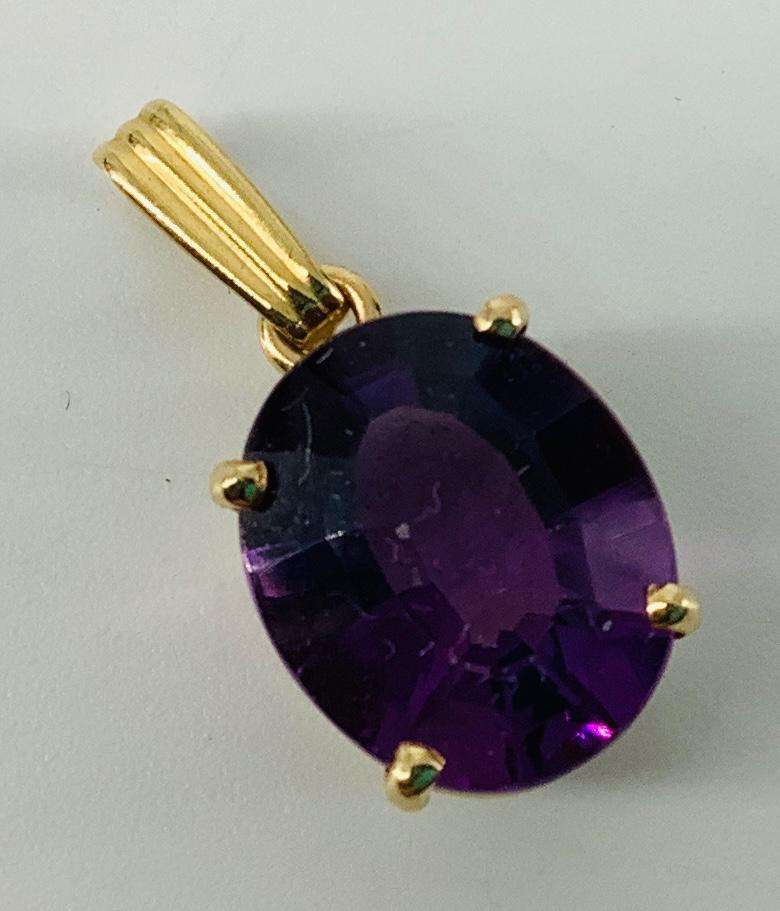 14kt Yellow Gold & Alexandrite Pendant: 14kt Yellow Gold & Alexandrite Pendant Measuring (0.85" in length) featuring an oval cut alexandrite center stone measuring (12.1mm x 10mm) stamped and tested (1.7 grams tw).