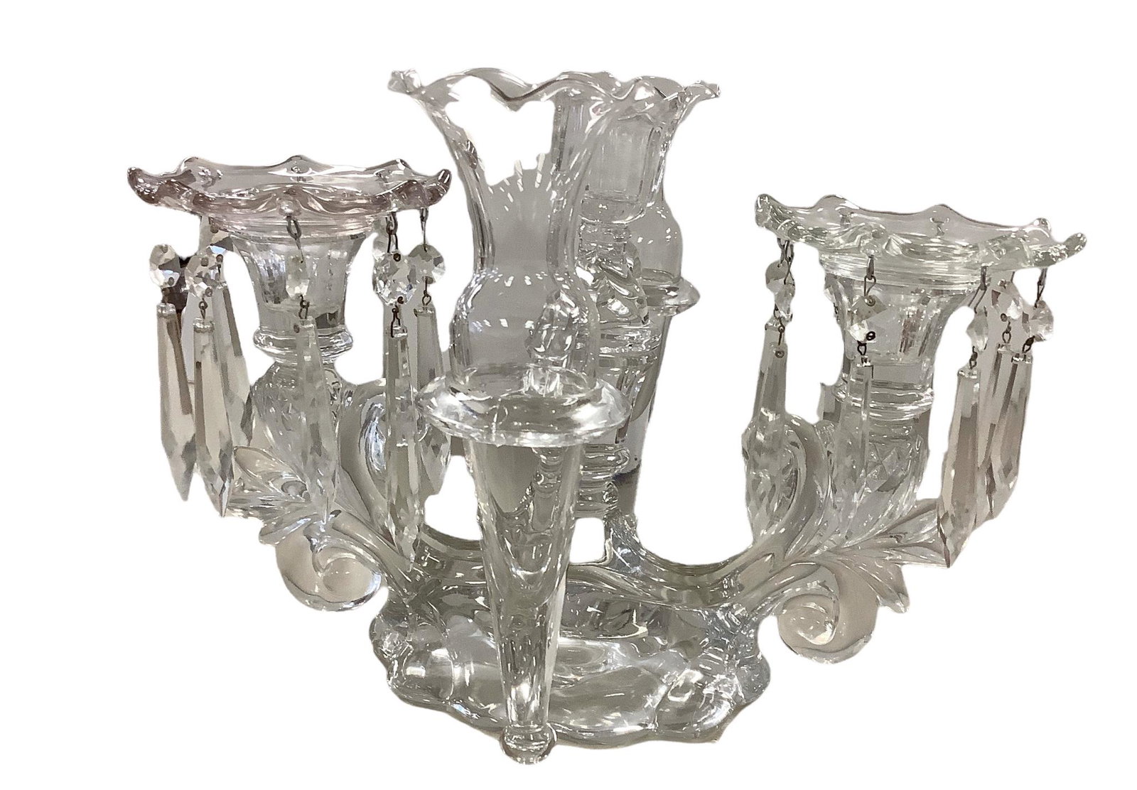 Crystal Clear Epergne Candelabra/Vase. Measures 9” tall and 12” wide. Comes with two: Crystal Clear Epergne Candelabra/Vase. Measures 9” tall and 12” wide. Comes with two extra bud vases and one hanging prism.