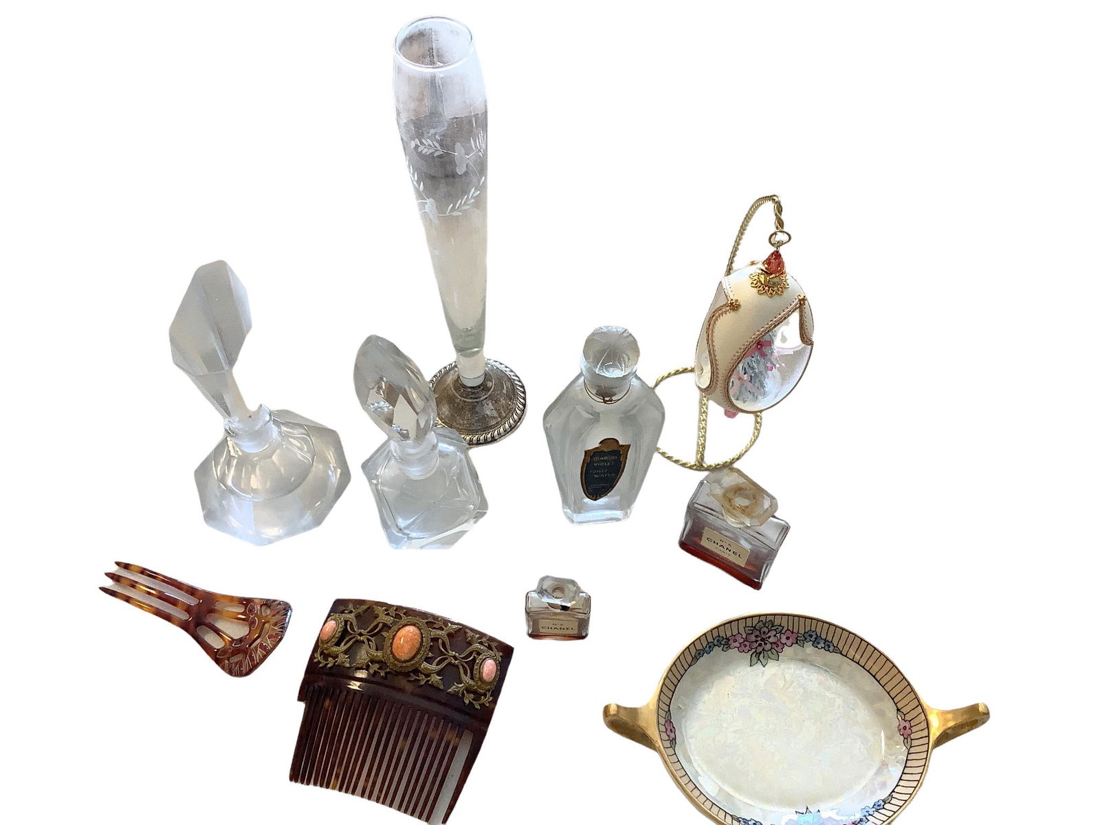 Lot of vintage Perfume bottles ranging from 2" to 6", two hair combs one has broken teeth. Dresser: Lot of vintage Perfume bottles ranging from 2" to 6", two hair combs one has broken teeth. Dresser plate from Czechoslovakia Glass etched vase with sterling silver base.10" tall no chips.