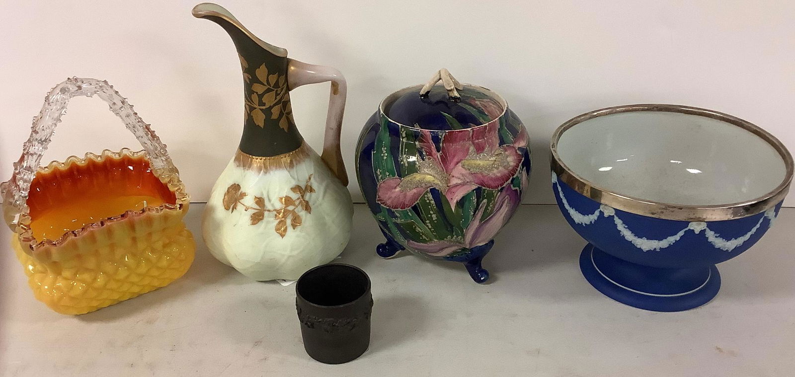 Lot includes a Thomas Webb Crown Milano pitcher @ 9" tall, a small basalt Wedgwood pottery cup Made: Lot includes a Thomas Webb Crown Milano pitcher @ 9" tall, a small basalt Wedgwood pottery cup Made in England, a silver plate Wedgwood bowl @ 7" wide from approx 1850, a yellow vintage Art glass bask