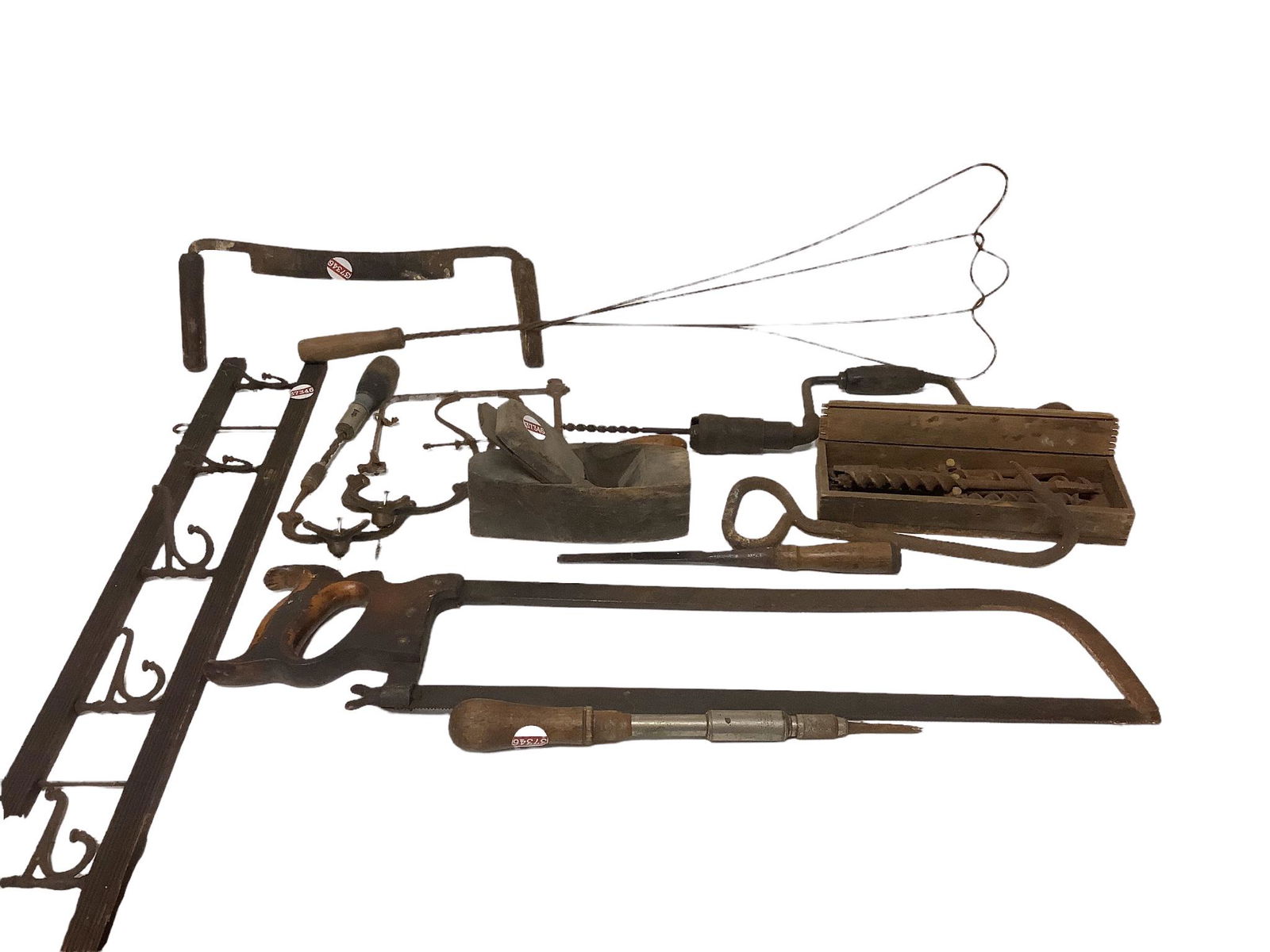 Lot of vintage wood and metal hand tools including saws, an ice hook and a rug beater.: Lot of vintage wood and metal hand tools including saws, an ice hook and a rug beater.