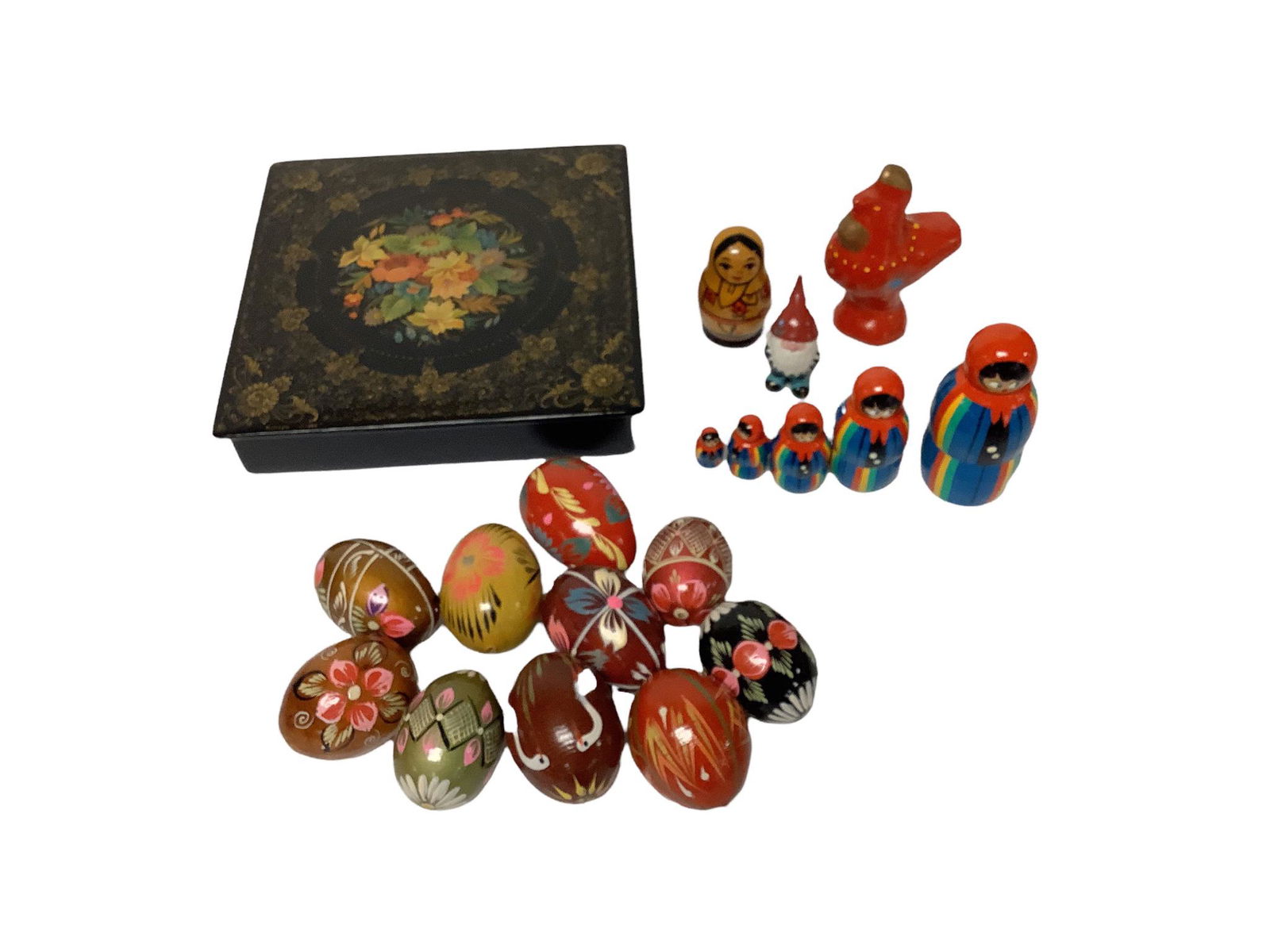 Lot including a lacquered wooden box with beautifully painted lid, 7.25" sq. x 1.5"h, 2 sets of: Lot including a lacquered wooden box with beautifully painted lid, 7.25" sq. x 1.5"h, 2 sets of nesting dolls and 10 painted wooden eggs.