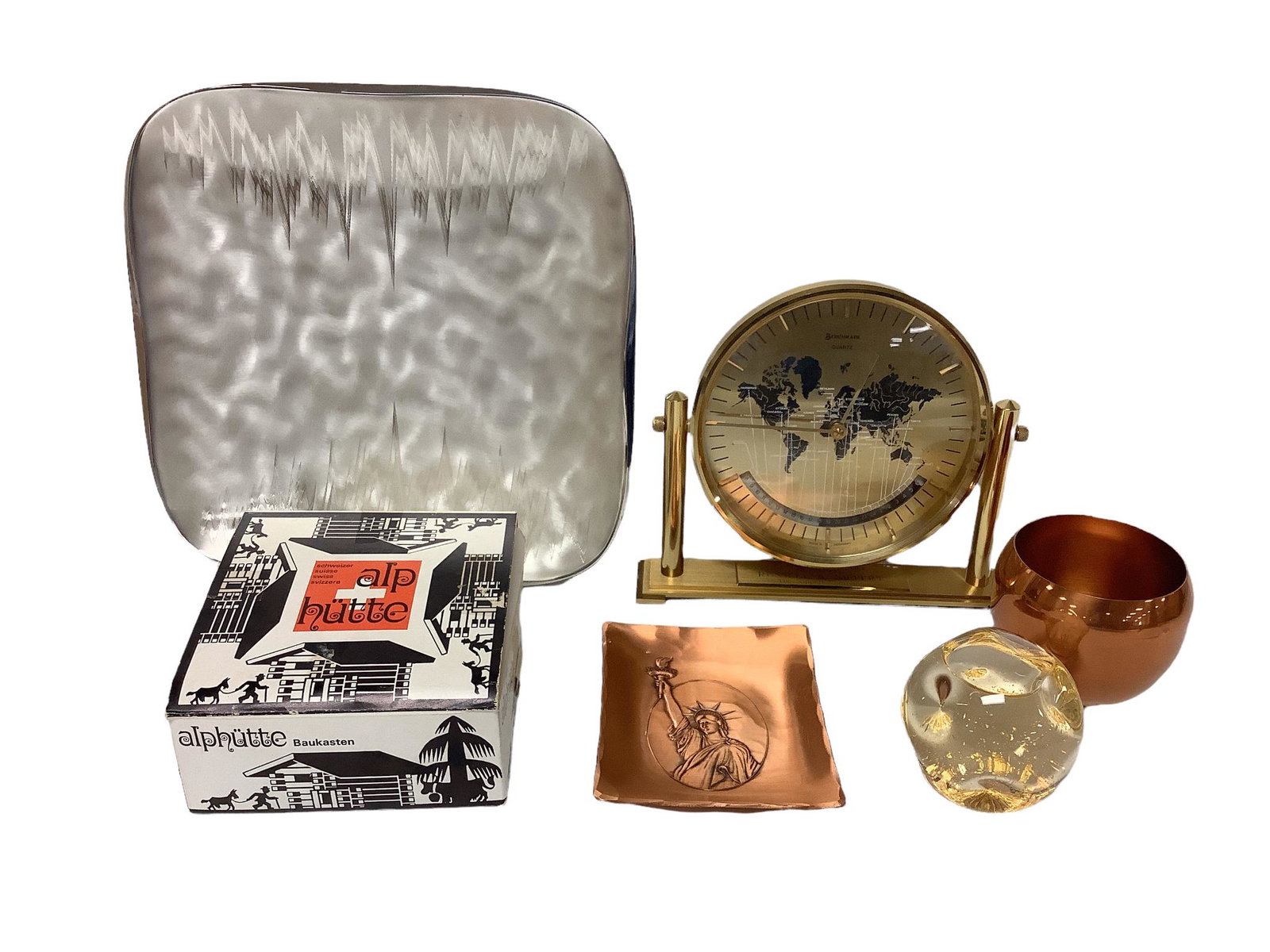 Lot including a paperweight/snow globe marked "Pure Alaskan Gold, El Dorado Gold Mine",: Lot including a paperweight/snow globe marked "Pure Alaskan Gold, El Dorado Gold Mine", 2.5"diameter, a build it yourself Swiss house with Swiss musical movement, a Statue of Liberty centennial celebr