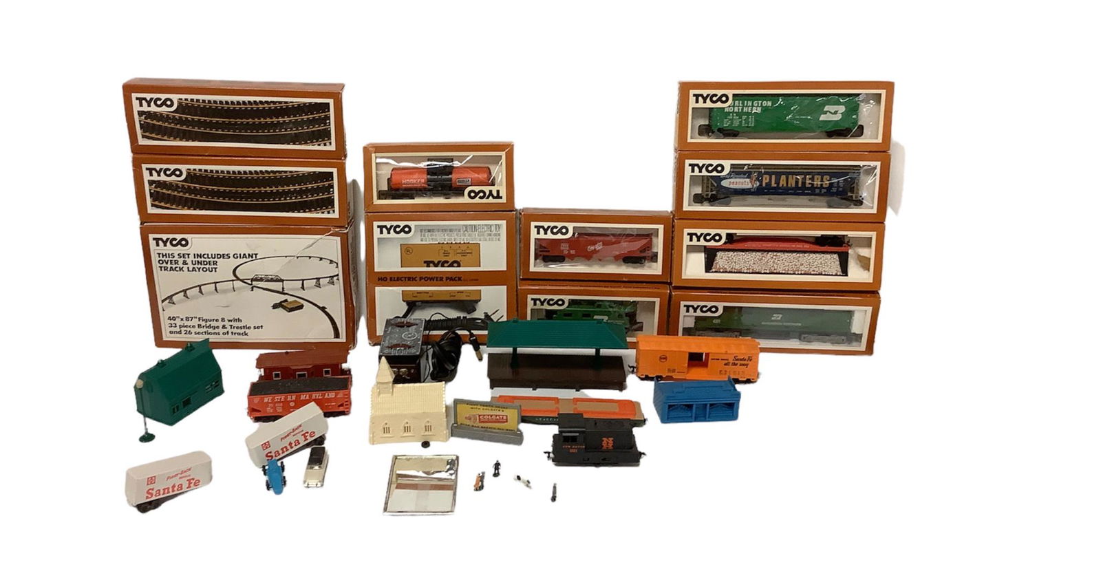 Tyco Train equipment 40 x 87 figure 8 with 33 bridges and trestle and 26 sections of track. Two box: Tyco Train equipment 40 x 87 figure 8 with 33 bridges and trestle and 26 sections of track. Two box of track. 12 cars. HO electric power pack and a small control panel Little figurines to set around t