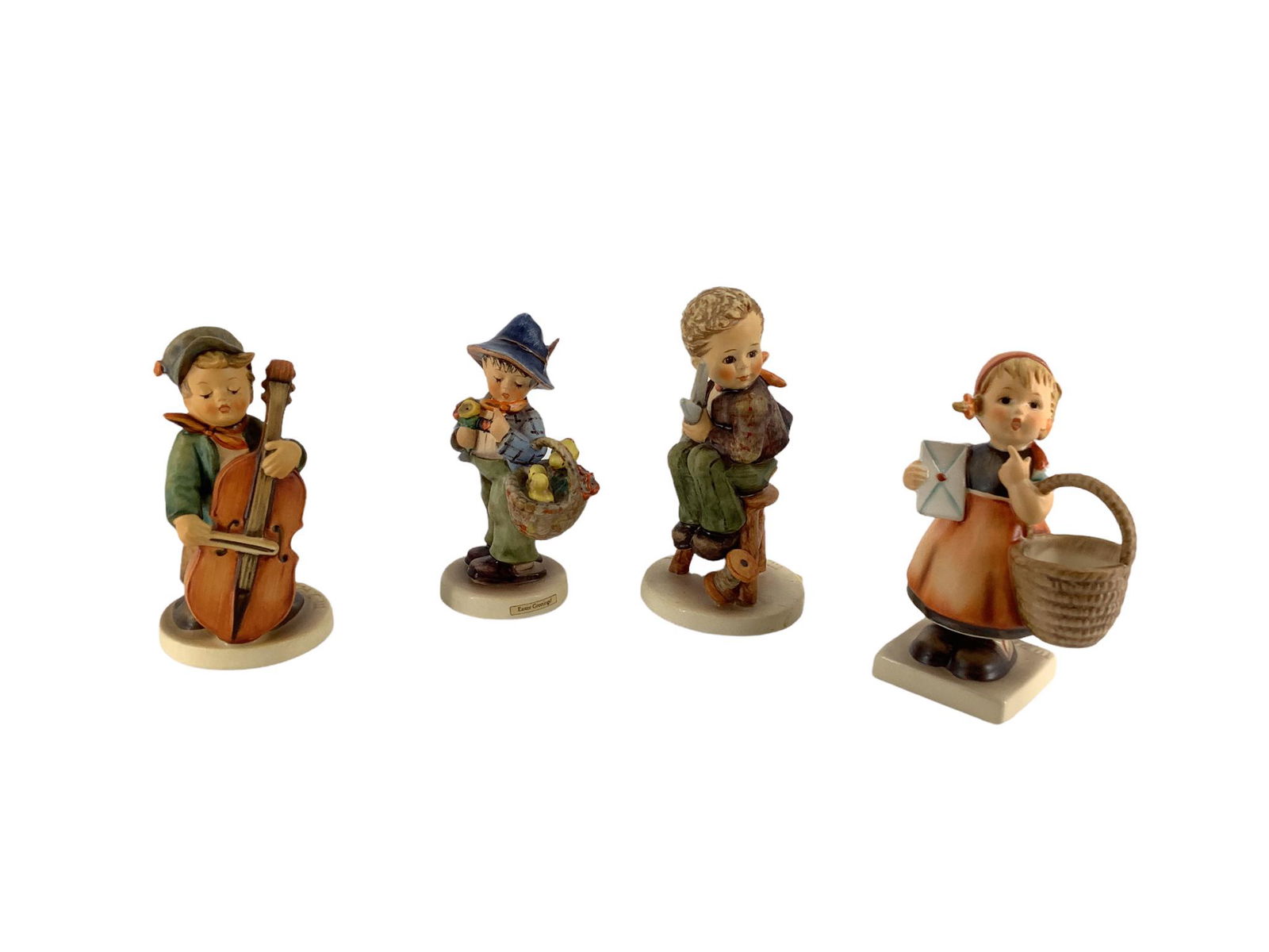 Lot of 4 Hummel figures which include "Sweet Music ", "Little Tailor", "Easter Greetings ", and (1 of 3)