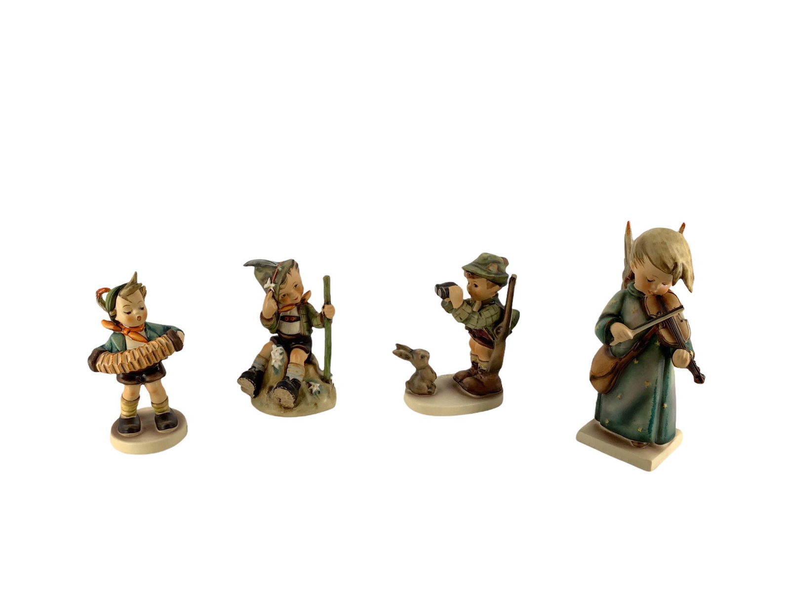 Lot of 4 Hummel figures which include "Good Hunting", "Mountaineer ", "Accordion Boy ", and (1 of 3)