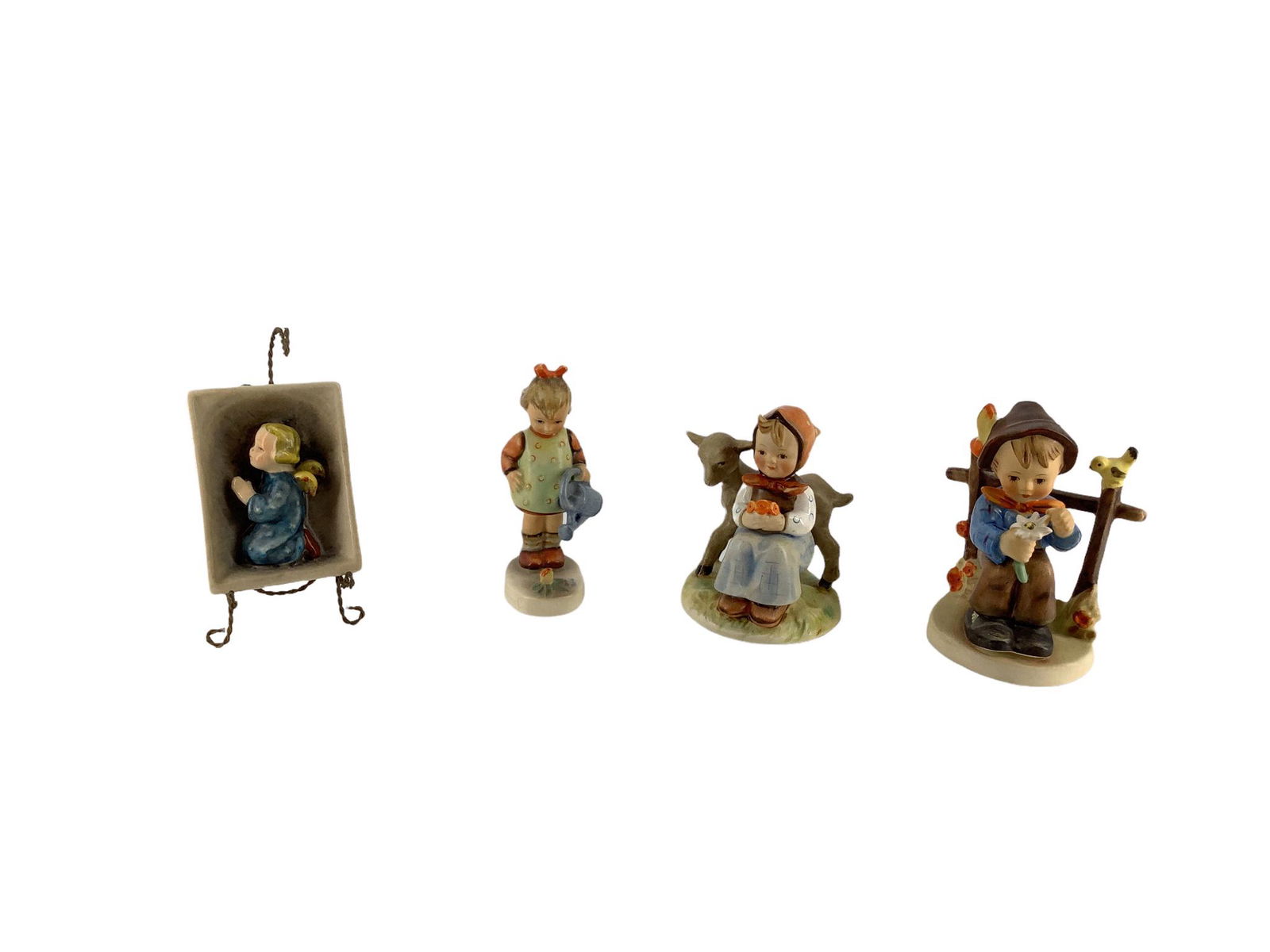 Lot of 4 Hummel figures which include "Little Gardener", "Friends", "She Loves Me", and praying (1 of 3)
