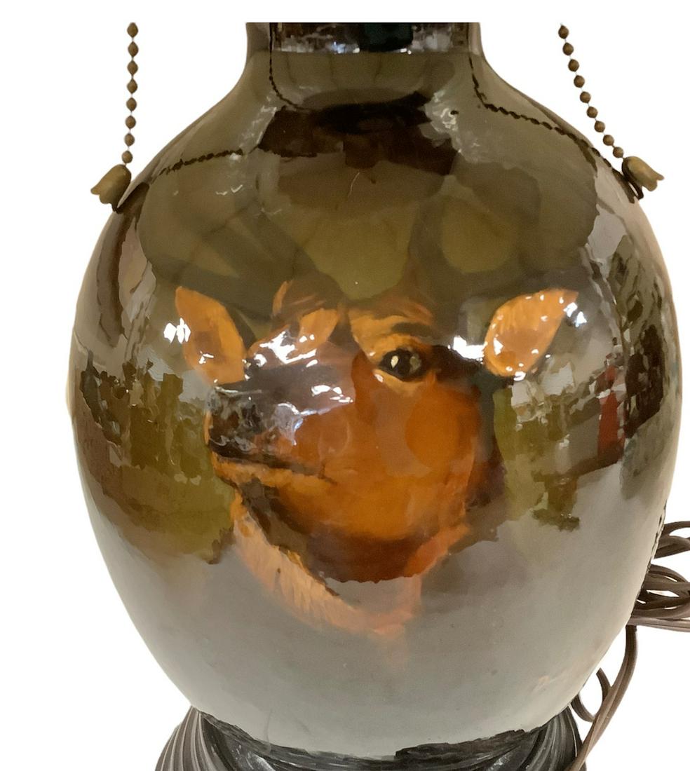 Weller Pottery Lamp signed by Dunlavy. 11" tall without shade. Picture of a deer face. Some crazing (1 of 3)