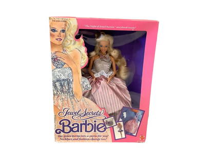 (1) Jewelry Secrets Barbie in her original box. Jewel Secrets Barbie is a pink boxed Barbie wearing: (1) Jewelry Secrets Barbie in her original box. Jewel Secrets Barbie is a pink boxed Barbie wearing a silver and pink dress that folds into a child's purse. She is Mint in the box and she looks great!