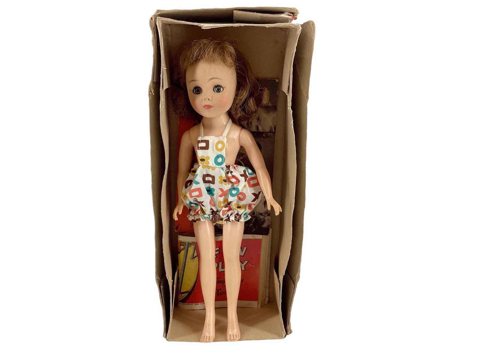 Ideal 10" Little Miss Revlon with root mohair wig, molded eyelashes, glass sleep eyes, closed mouth: Ideal 10" Little Miss Revlon with root mohair wig, molded eyelashes, glass sleep eyes, closed mouth and painted facial features. She is wearing a "X & O" romper. Original box and brochures included.