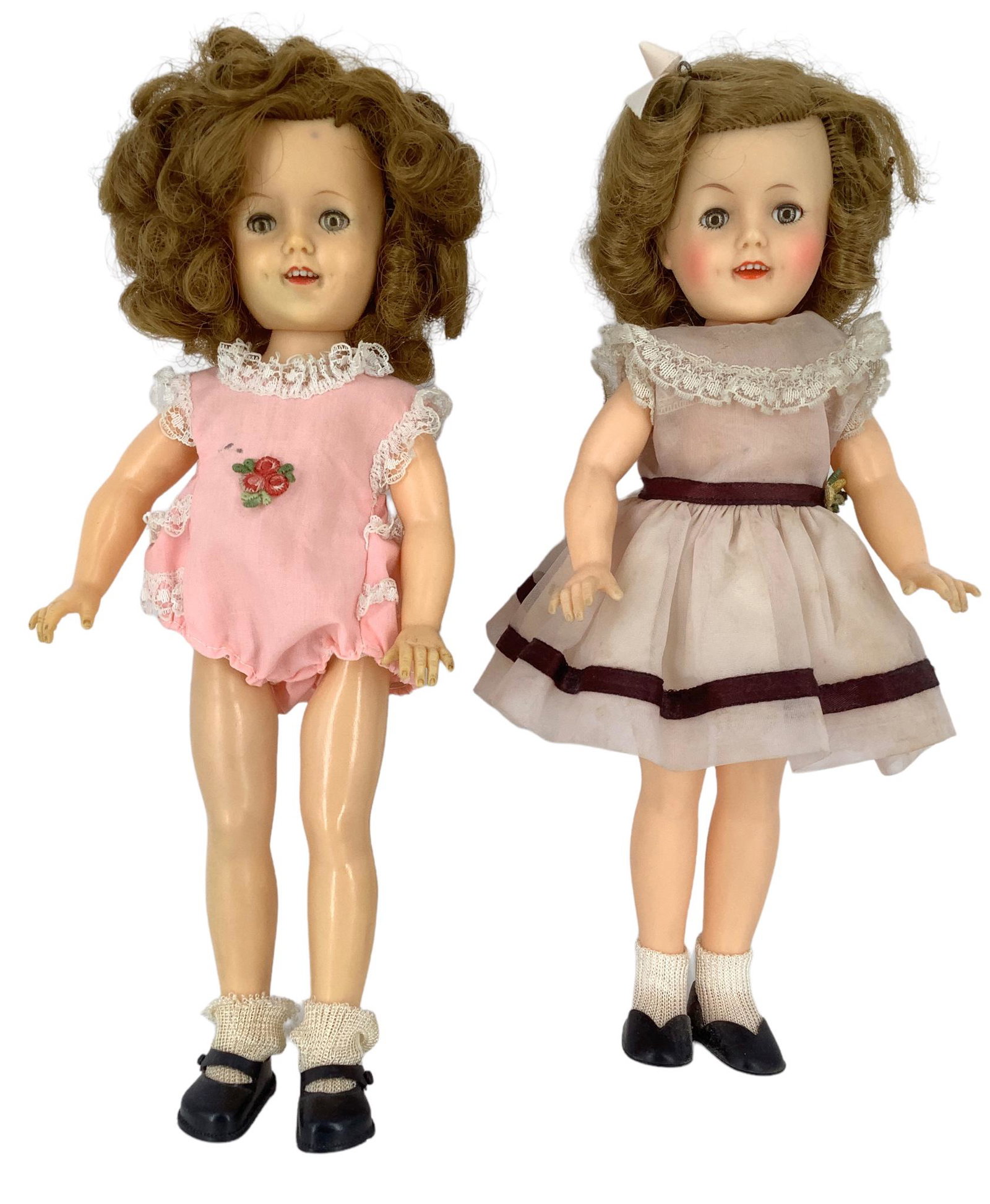 Pair of Ideal Shirley Temple 11 1/2" dolls hard plastic, rooted mohair wigs, molded eyelashes, glass: Pair of Ideal Shirley Temple 11 1/2" dolls hard plastic, rooted mohair wigs, molded eyelashes, glass sleep eyes, open mouth with teeth and painted facial features. One is wearing a pink organdy dress 