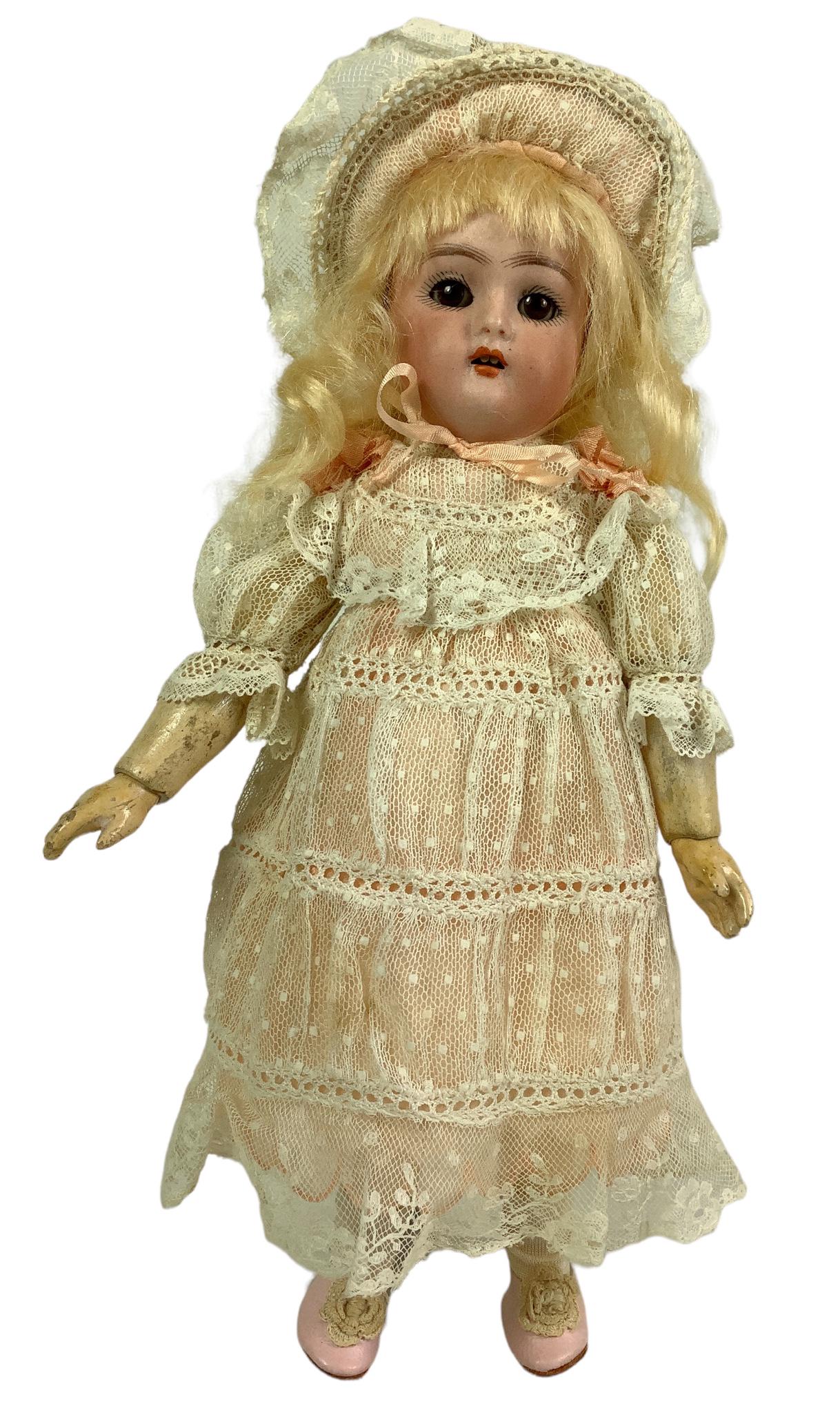 Simon & Halbig K&R bisque socket head girl. 9 1/4" doll with mohair wig, glass sleep eyes, open: Simon & Halbig K&R bisque socket head girl. 9 1/4" doll with mohair wig, glass sleep eyes, open mouth with teeth, on fully jointed composition body. Nice cabinet size doll with good bisque, appropriat