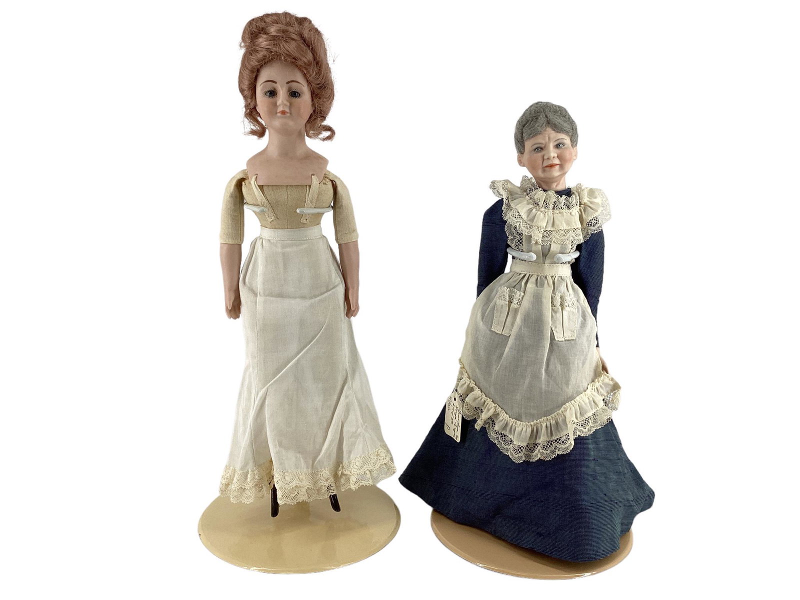 Pair of bisque dolls including, 13 1/2" shoulder head doll with auburn mohair wig, painted eyelashes: Pair of bisque dolls including, 13 1/2" shoulder head doll with auburn mohair wig, painted eyelashes and facial features and glass eyes. She has painted on boots, organdy slip and pantaloons trimmed i