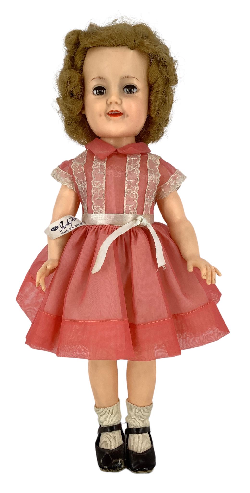 Ideal 19" Shirley Temple dolls, rooted mohair wig, molded eyelashes, glass flirty sleep eyes, open: Ideal 19" Shirley Temple dolls, rooted mohair wig, molded eyelashes, glass flirty sleep eyes, open mouth with teeth and painted facial features. She is wearing a tagged pink organdy dress with taffeta