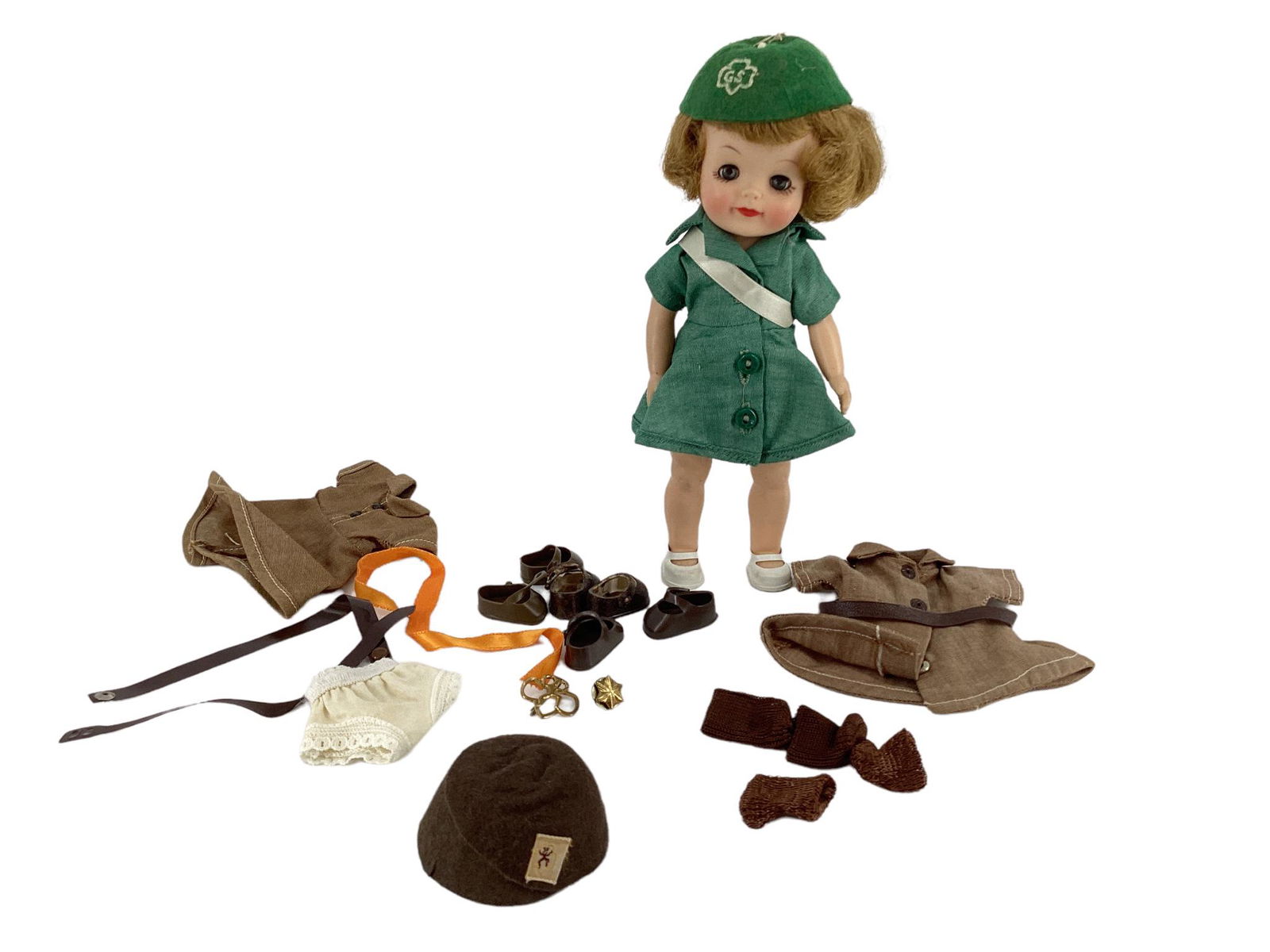 Effanbee 8" Girl Scout doll with mohair wig, molded eyelashes, glass sleep eyes, painted eyelashes: Effanbee 8" Girl Scout doll with mohair wig, molded eyelashes, glass sleep eyes, painted eyelashes and facial features and closed mouth. She is wearing green Girl Scout outfit with white ribbon across