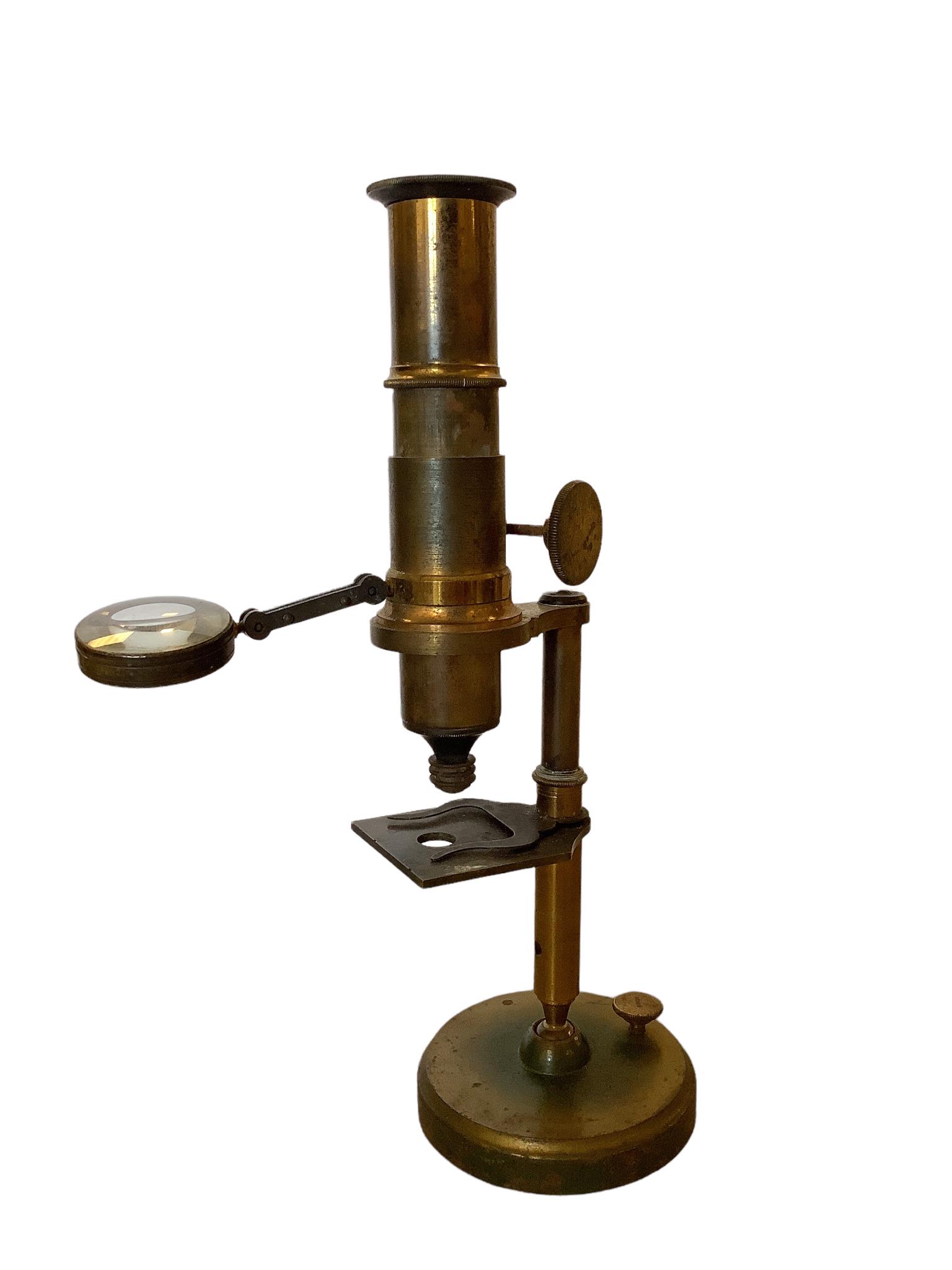 French brass microscope with magnifying glass. It stands 9 1/8” high and expands to 10 (1 of 2)