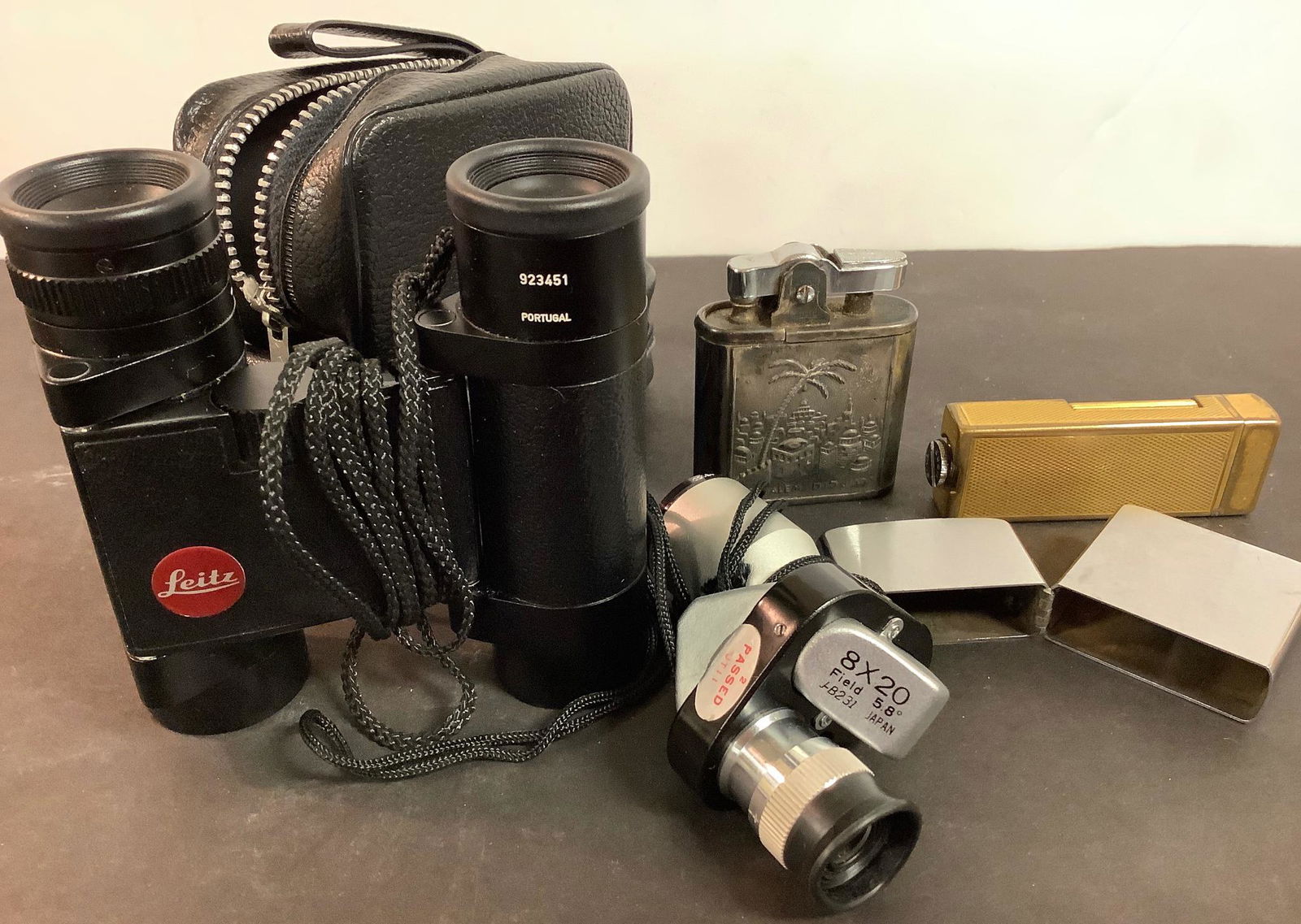 Misc lot includes 2 lighters (one marked “Israel”), a matchsafe, Leitz binoculars marked (1 of 2)