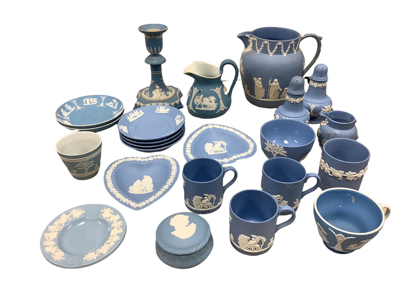 Large lot of Wedgwood blue Jasperware and 1 Wedgwood Queenware ashtray. The candlestick is 5: Large lot of Wedgwood blue Jasperware and 1 Wedgwood Queenware ashtray. The candlestick is 5 3/4” tall. One of the cups has been repaired and the small creamer has a broken handle.