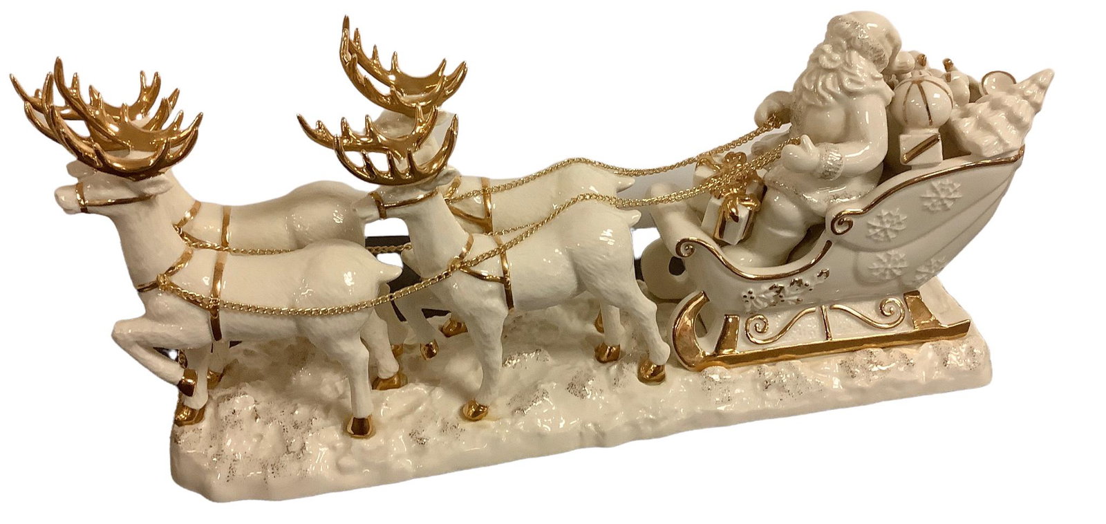 Mikasa “Here Comes Santa Claus” large porcelain figurine measuring 16” long. Piece: Mikasa “Here Comes Santa Claus” large porcelain figurine measuring 16” long. Piece has 4 reindeer, gold trim and chain detail.