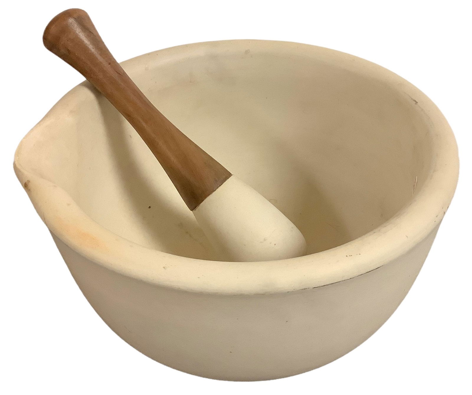 A heavy stone mortar and pestle set @ approx 11” wide and 6” tall with one side carved (1 of 2)