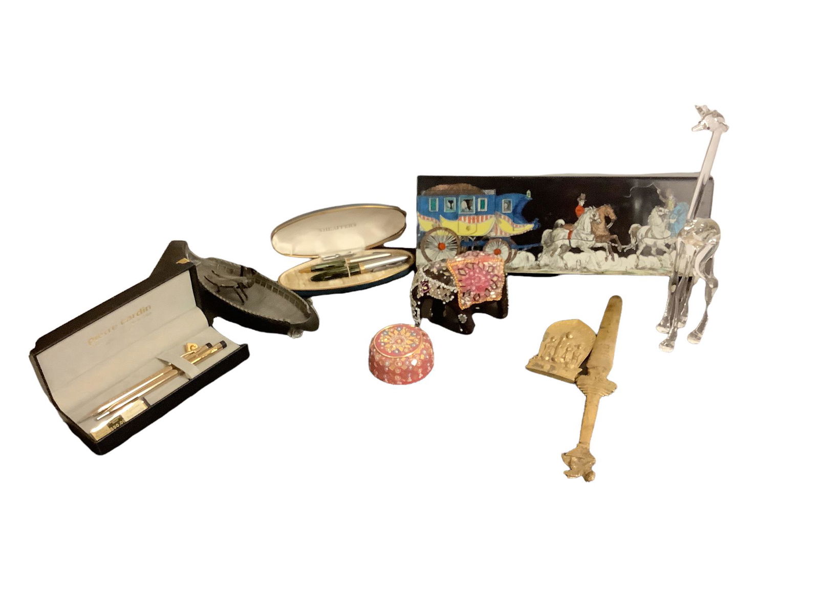 Pierre Cardin pen set used. Sheaffer pen set used. Blown glass giraffe 9” high. Itali letter: Pierre Cardin pen set used. Sheaffer pen set used. Blown glass giraffe 9” high. Itali letter opener. 3” metal bug.metal boat 8” long. Jewel elephant.