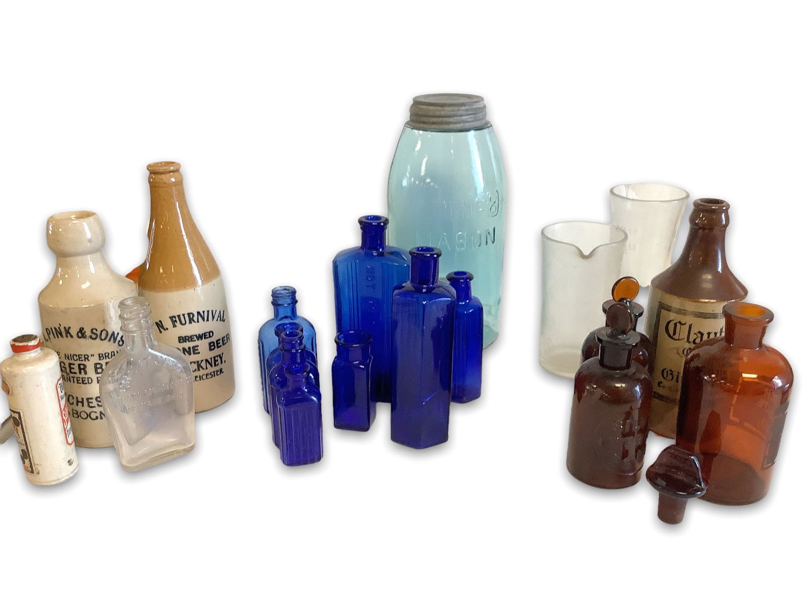 Lot of vintage glass bottles 8 cobalt blue 3 Amber 1 clear . Two glass measuring containers. Three (1 of 2)