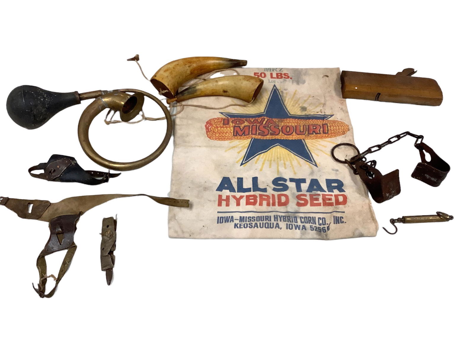 Lot of miscellaneous including primitive corn husking tools, All Star seed bag, rusty cow kickers, (1 of 1)