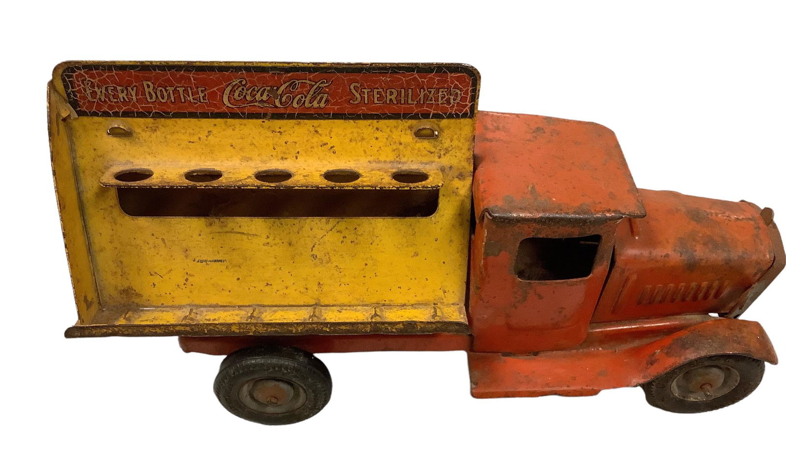 Vintage 1930 Metalcraft Corp. St. Louis Coca-Cola delivery truck . Pressed steel. Two bottle racks .: Vintage 1930 Metalcraft Corp. St. Louis Coca-Cola delivery truck . Pressed steel. Two bottle racks . All 4 tires â€œ Goodrich Silvertown" some rust. Grill on front of truck attached.