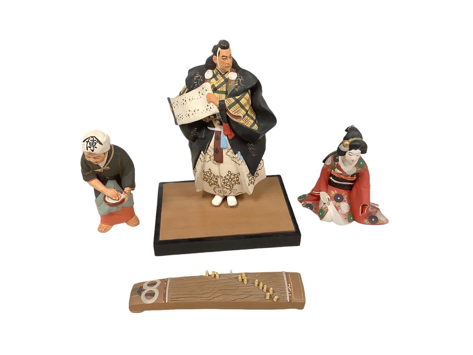 Lot of 3 Hakata dolls ranging in height from 7" - 11" with 1 stand and a decorative koto, 9.5"h. (1 of 1)