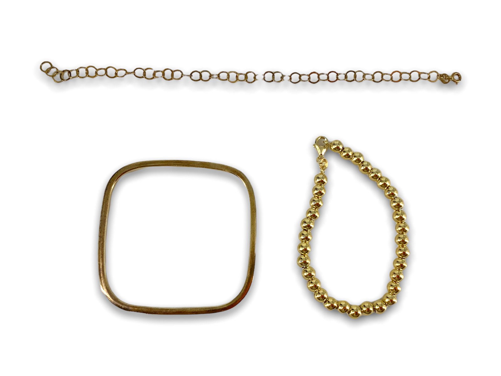 Three Vermeil Bracelets: Three Vermeil Bracelets One measuring 7.5" in length with polished spherical beads and a lobster clasp closure, one measuring 7.5" in elegant with flat circular links and lastly a square bangle with r