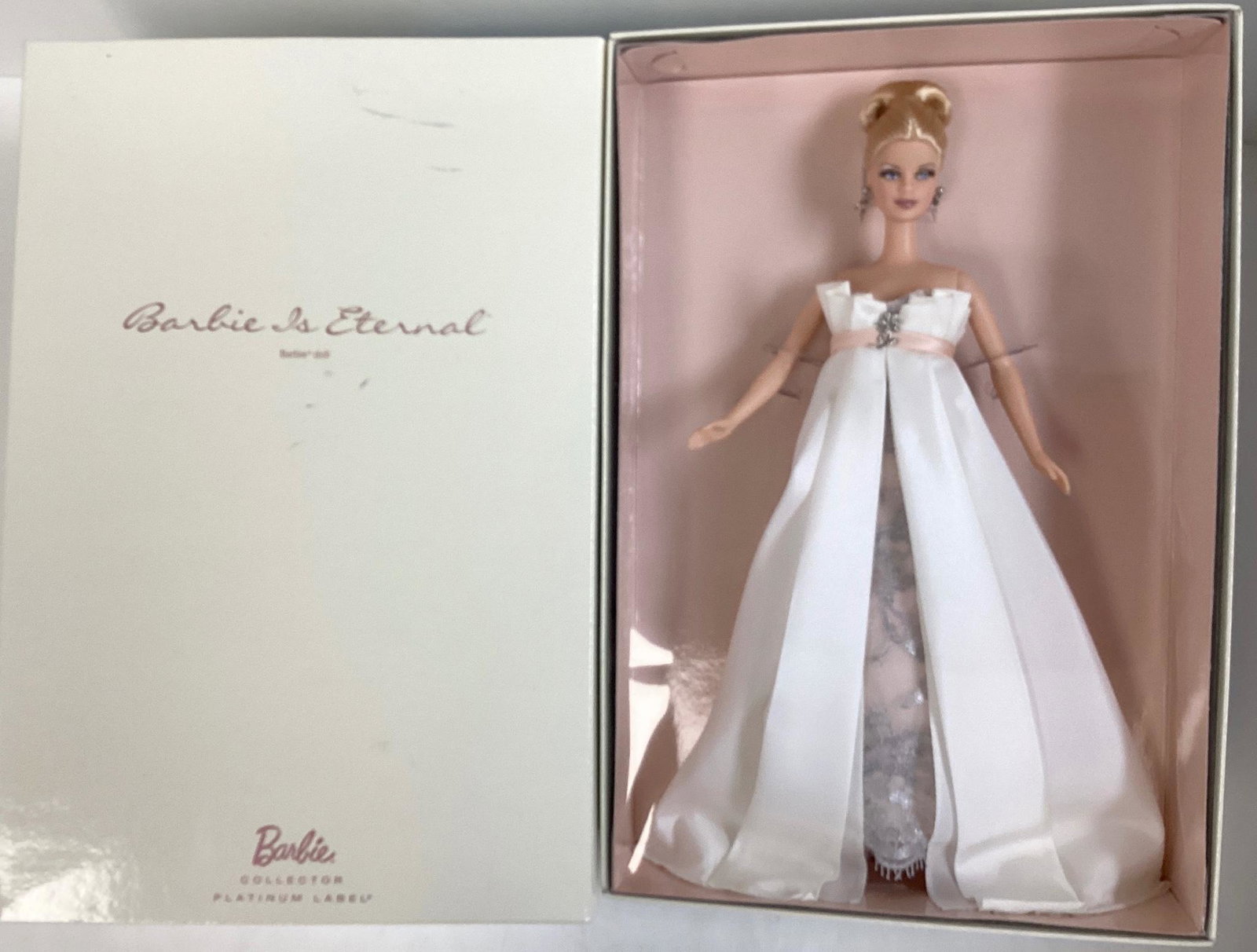 (1) Barbie is Eternal Barbie Doll, a Barbie Collector Platinum Label from The National Barbie Doll: (1) Barbie is Eternal Barbie Doll, a Barbie Collector Platinum Label from The National Barbie Doll Collectors Convention Souvenir Doll. 2012. Gorgeous Barbie wears an off-white tafetta gown worn over