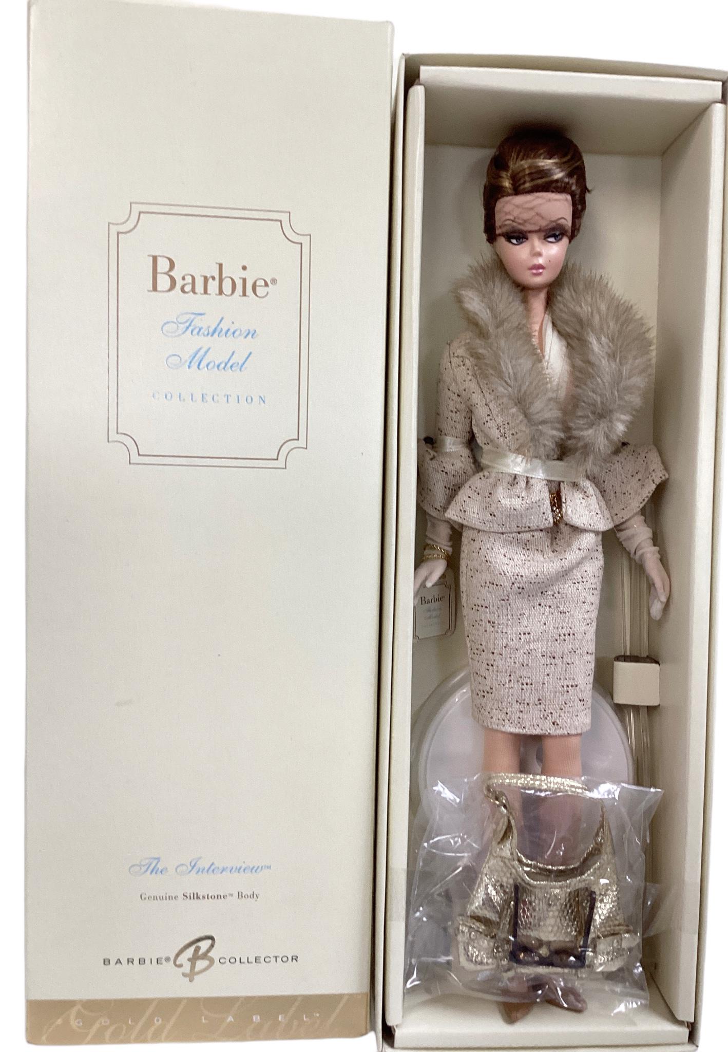 (1) Beautiful Silkstone Barbie called The Interview, a BFMC Gold Label Barbie with no more than: (1) Beautiful Silkstone Barbie called The Interview, a BFMC Gold Label Barbie with no more than 10,400 worldwide. Barbie is in a superb suit with faux fur and comes with accessories. Barbie is a NRFB