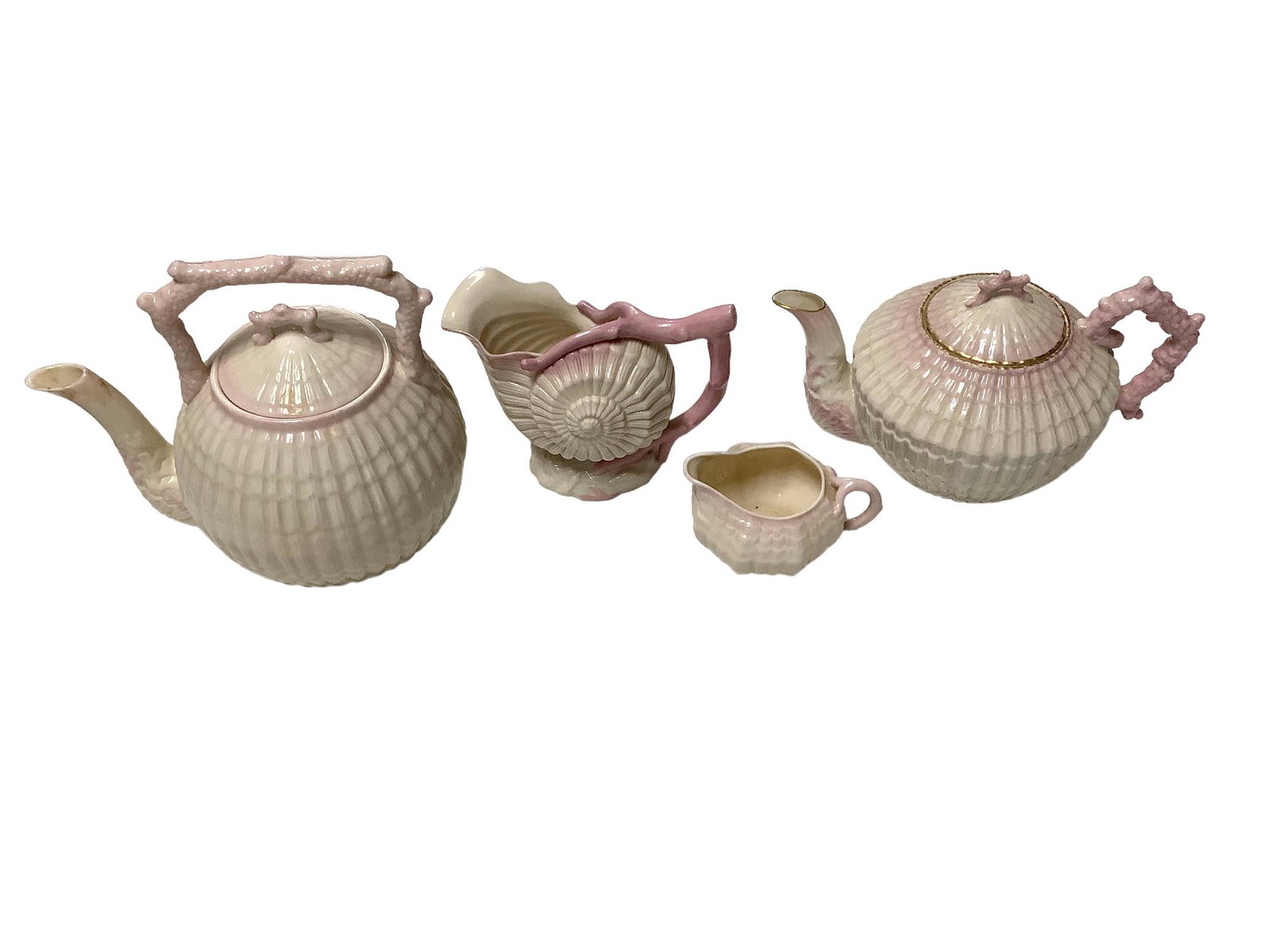 Lot of four pieces of Belleek including a large pin tint Limpet Tea Kettle, 7.5”h, a large (1 of 2)