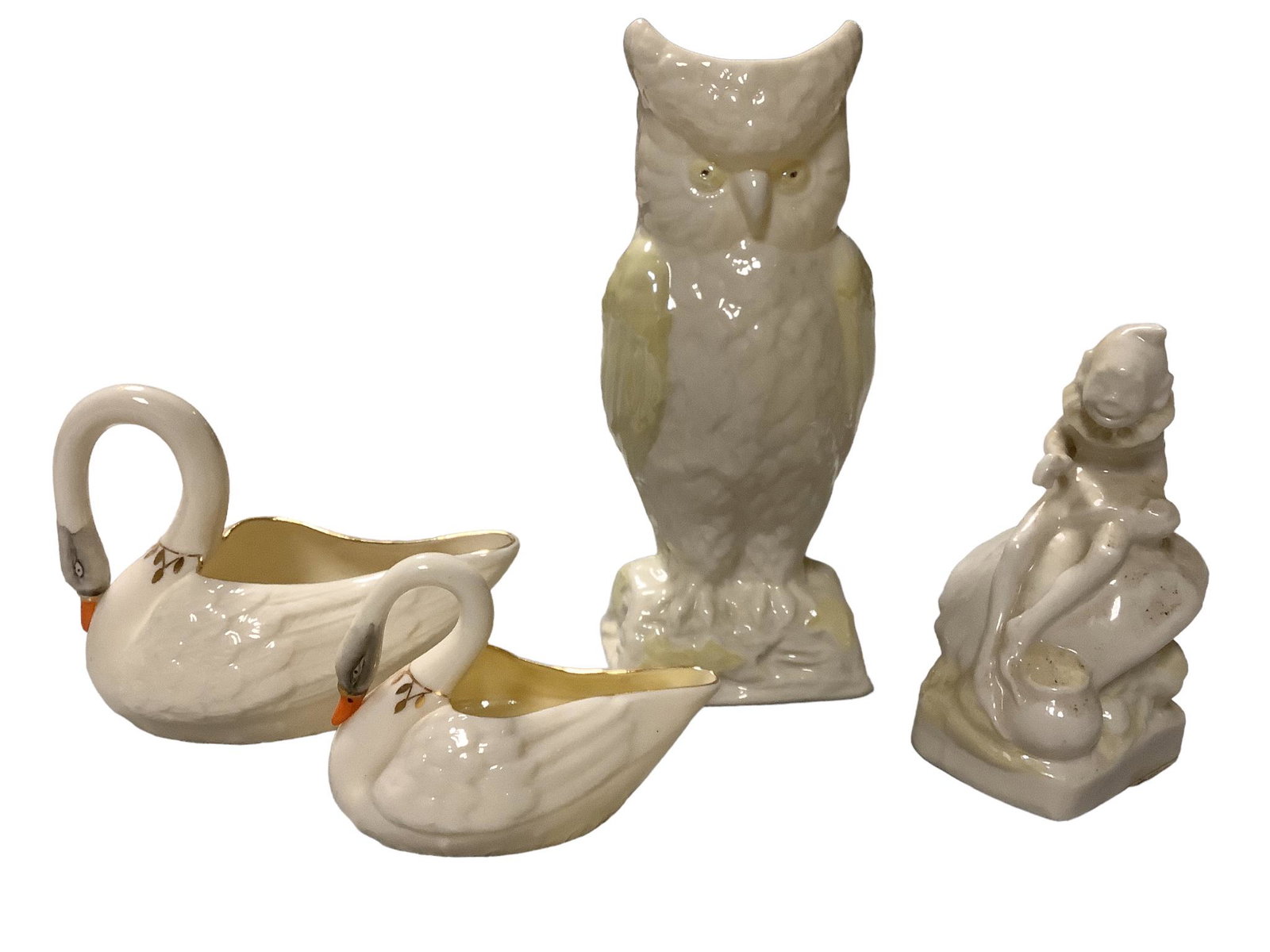 Lot of four pieces of Belleek including an 8.25"h Owl vase, a 5.25"h Leprechaun, a large decorated (1 of 2)