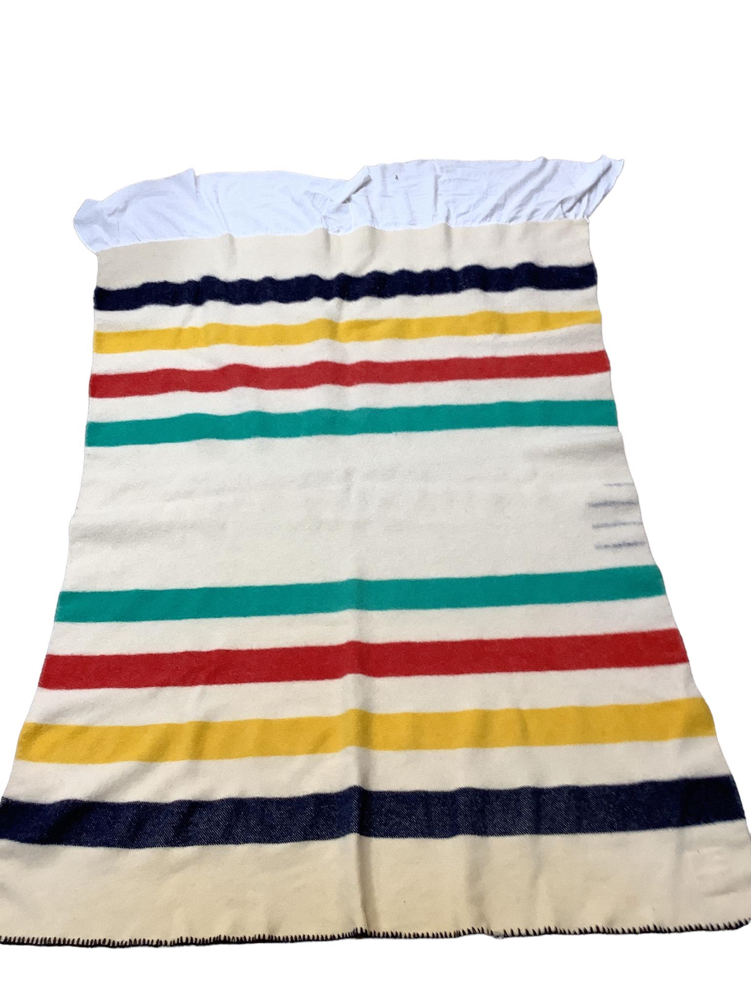 Hudson Bay wool blanket measuring 66 x 55". Bottom has white cotton unfinished edge ruffle sewn onto (1 of 2)