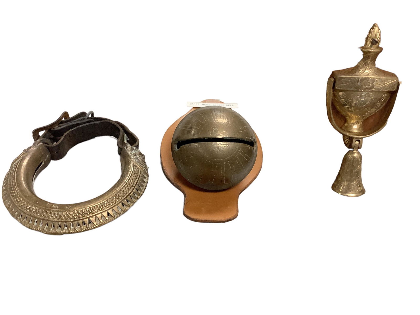 Lot of three items. Very old elephant ankle ring, large brass Sleighbell, door knocker with bell. (1 of 1)