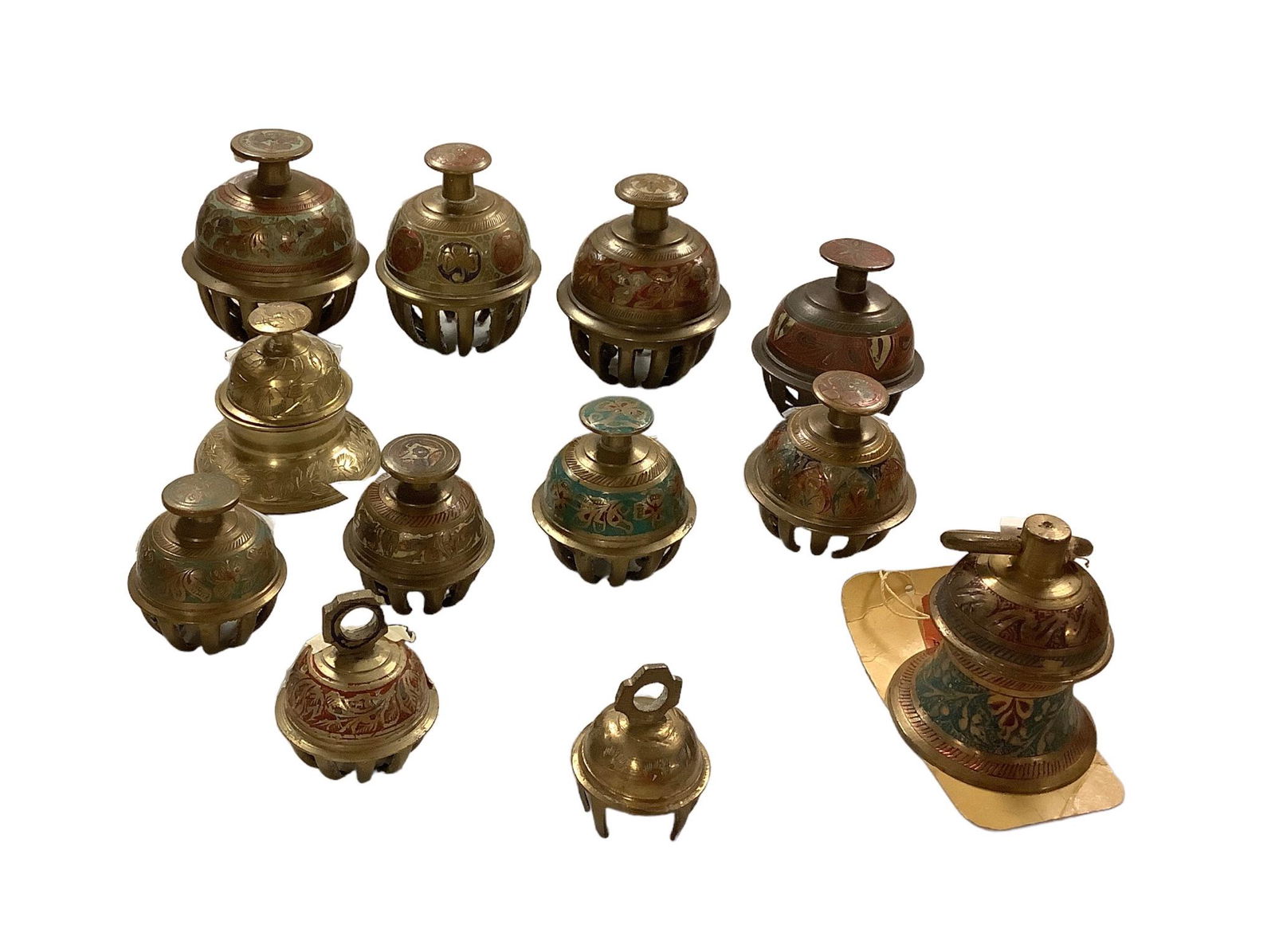 Lot of 12. Ten painted Indian elephant bells in graduated sizes. One etched brass elephant bell with (1 of 3)