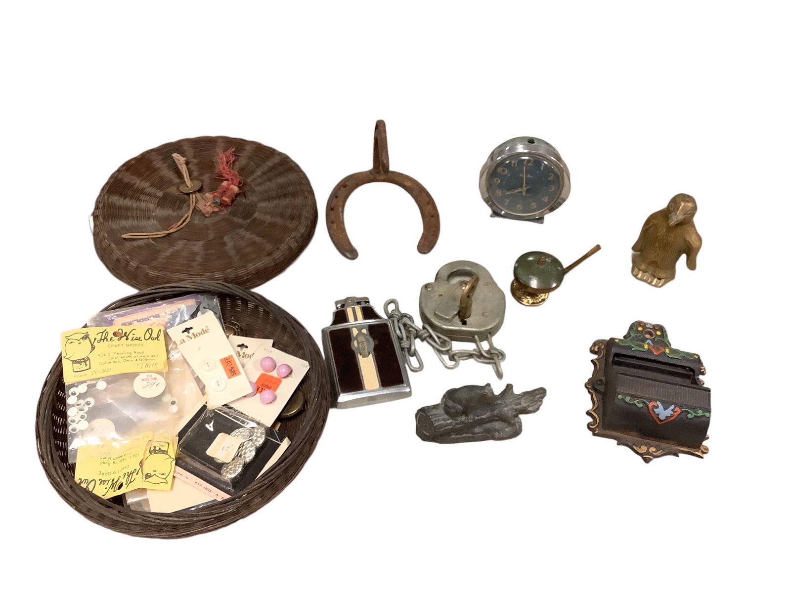 Lot including a vintage sewing basket with buttons, a rusty horseshoe wall hanging, a cast iron (1 of 1)