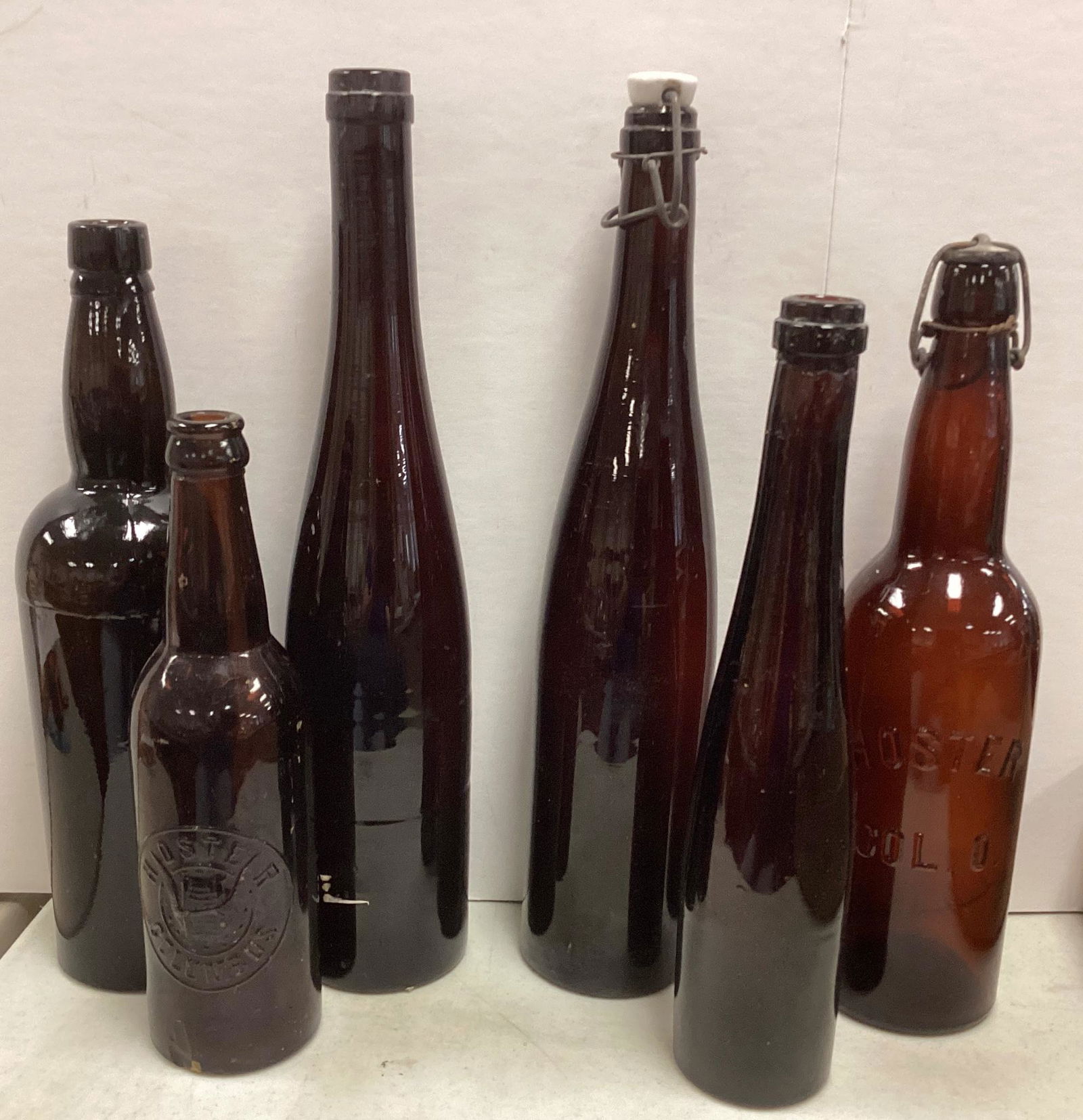 Lot of (6) brown glass bottles ranging in size from 9 3/4"-14" including Hoster, Columbus, Ohio. (2) (1 of 3)